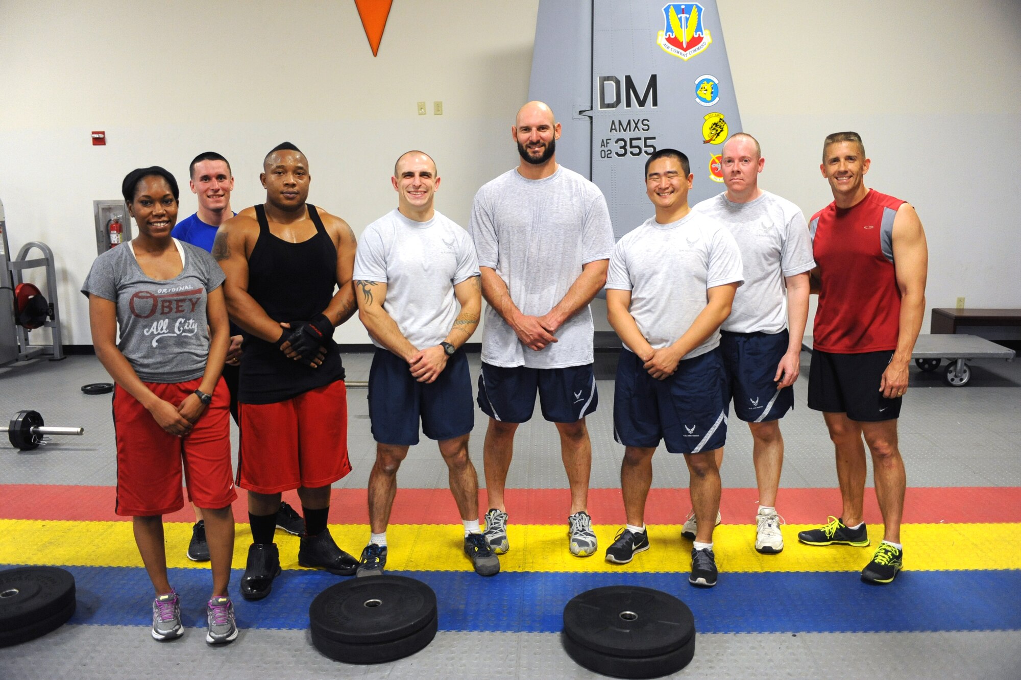 Desert Lightning Team members pose with Jarret Johnson, linebacker for the San Diego Chargers of the National Football League, following a workout at Davis-Monthan Air Force Base, Ariz., March 3, 2014.  D-M acknowledged the physical pillar of Comprehensive Airmen Fitness Day by offering Airmen a chance to work out with Johnson.  (U.S. Air Force Photo by Airman 1st Class Chris Massey)