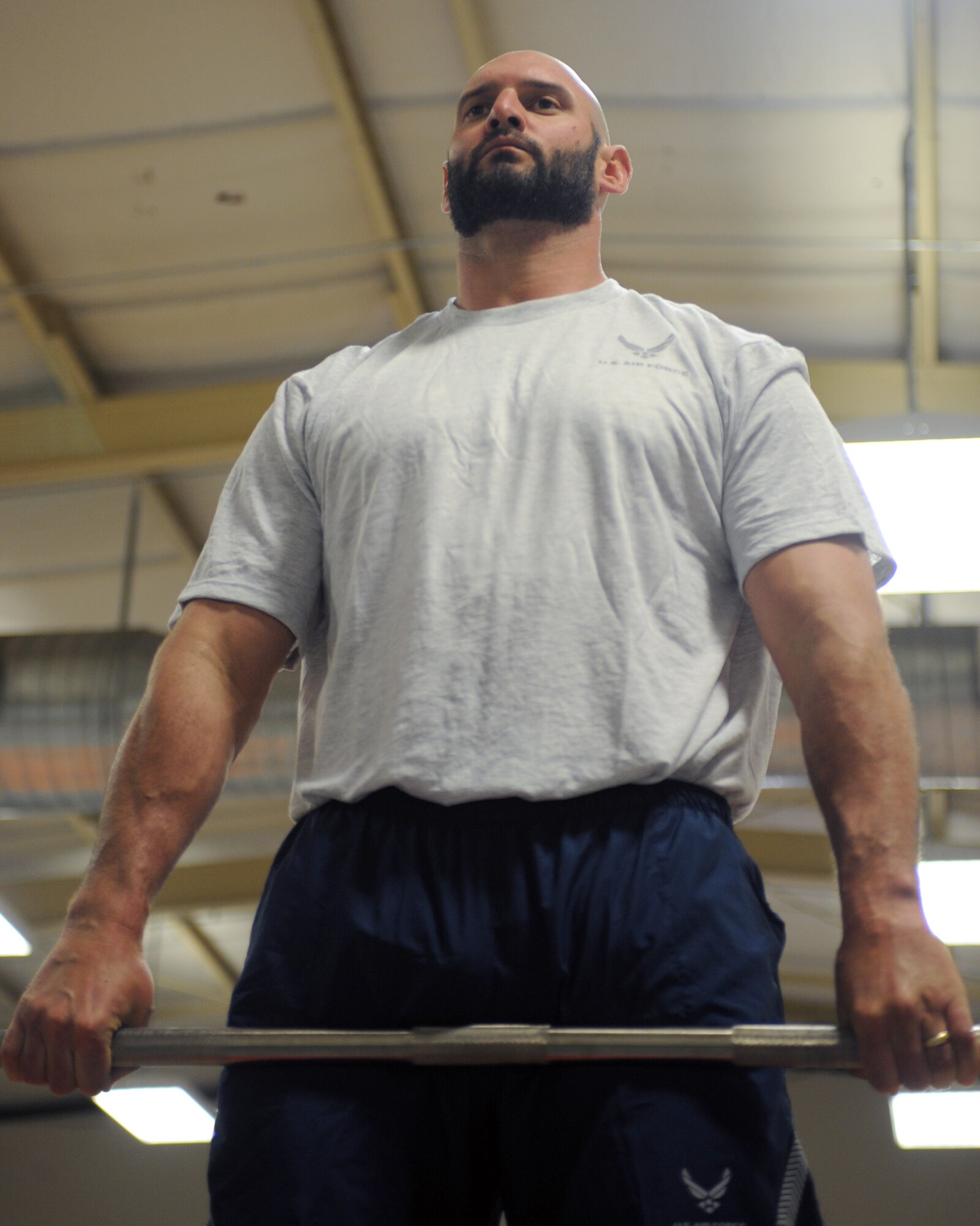 Jarret Johnson, linebacker for the San Diego Chargers of the National Football League, rests in the down position of an exercise during circuit training at Davis-Monthan Air Force Base, Ariz., March 3, 2104.  During his visit, Johnson participated in multiple workouts with Desert Lightning Team members recognizing the physical pillar of Comprehensive Airmen Fitness Day.  