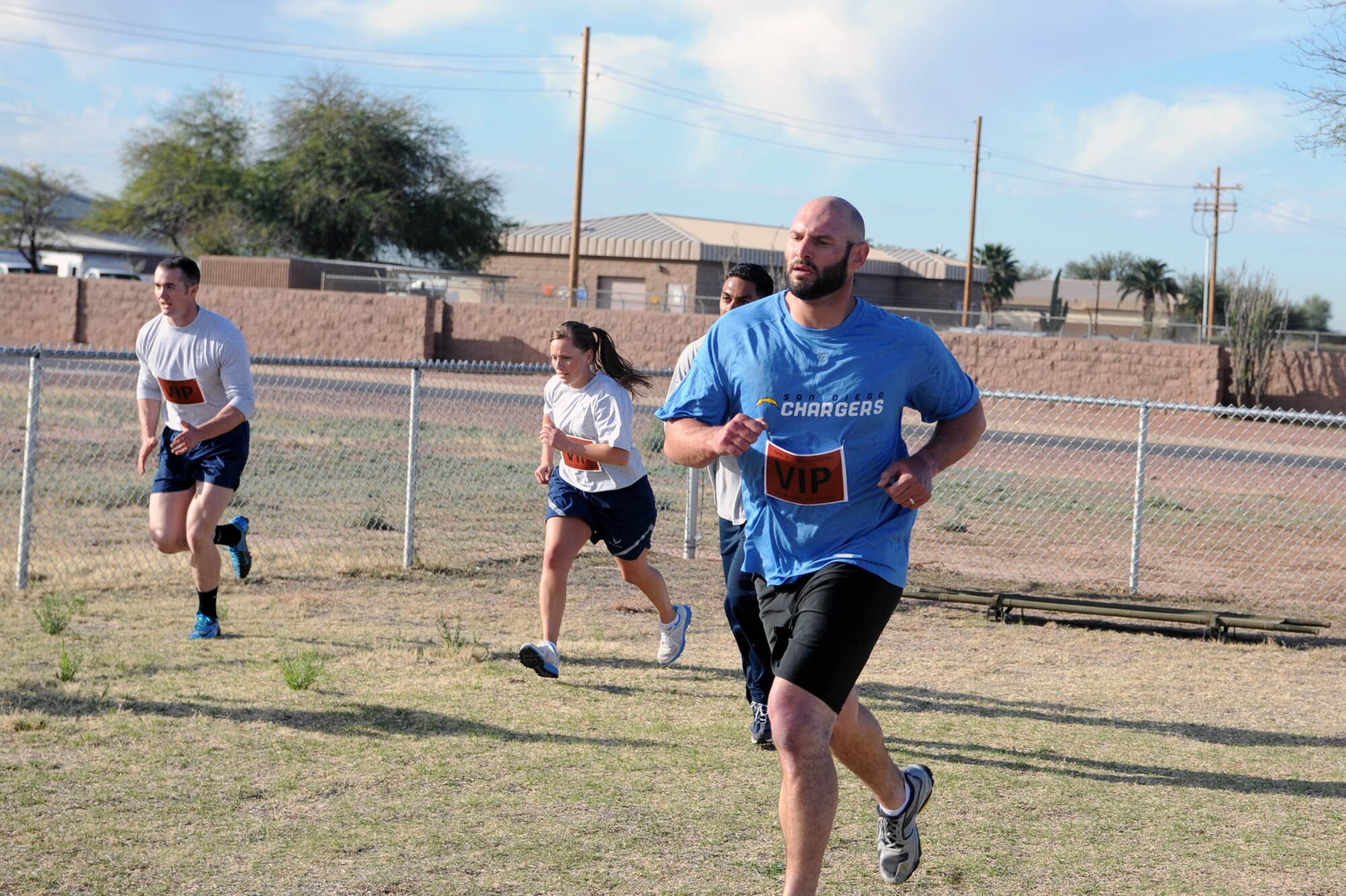 Members of ?Team VIP?, including Jarret Johnson, linebacker for the San Diego Chargers of the National Football League, sprint during a timed Comprehensive Airmen Fitness Day competition at Davis-Monthan Air Force Base, Ariz., March 3, 2014.  More than 50 Desert Lightning Team members participated in the competition with ?Team VIP? finishing with the fastest time.  (U.S. Air Force Photo by Airman 1st Class Chris Massey)