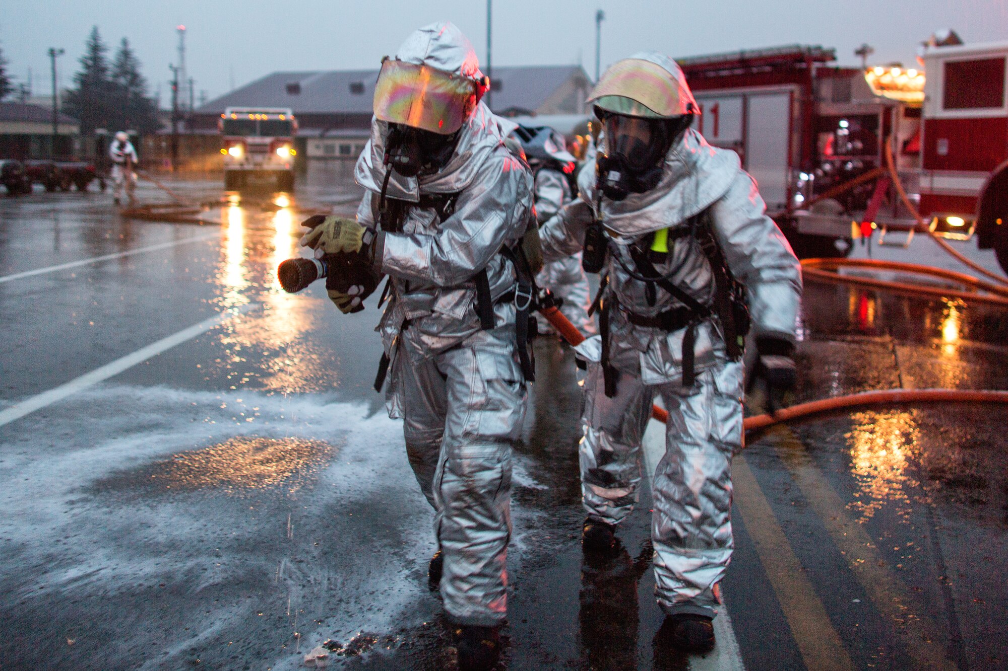 Yokota firefighters approach a simulated vehicle explosion during a Samurai Readiness Inspection at Yokota Air Base, Japan, March 5, 2014. The inspection was designed to evaluate Yokota’s ability to provide airlift capabilities while responding to a variety of contingency response scenarios. (U.S. Air Force photo by Osakabe Yasuo/Released)