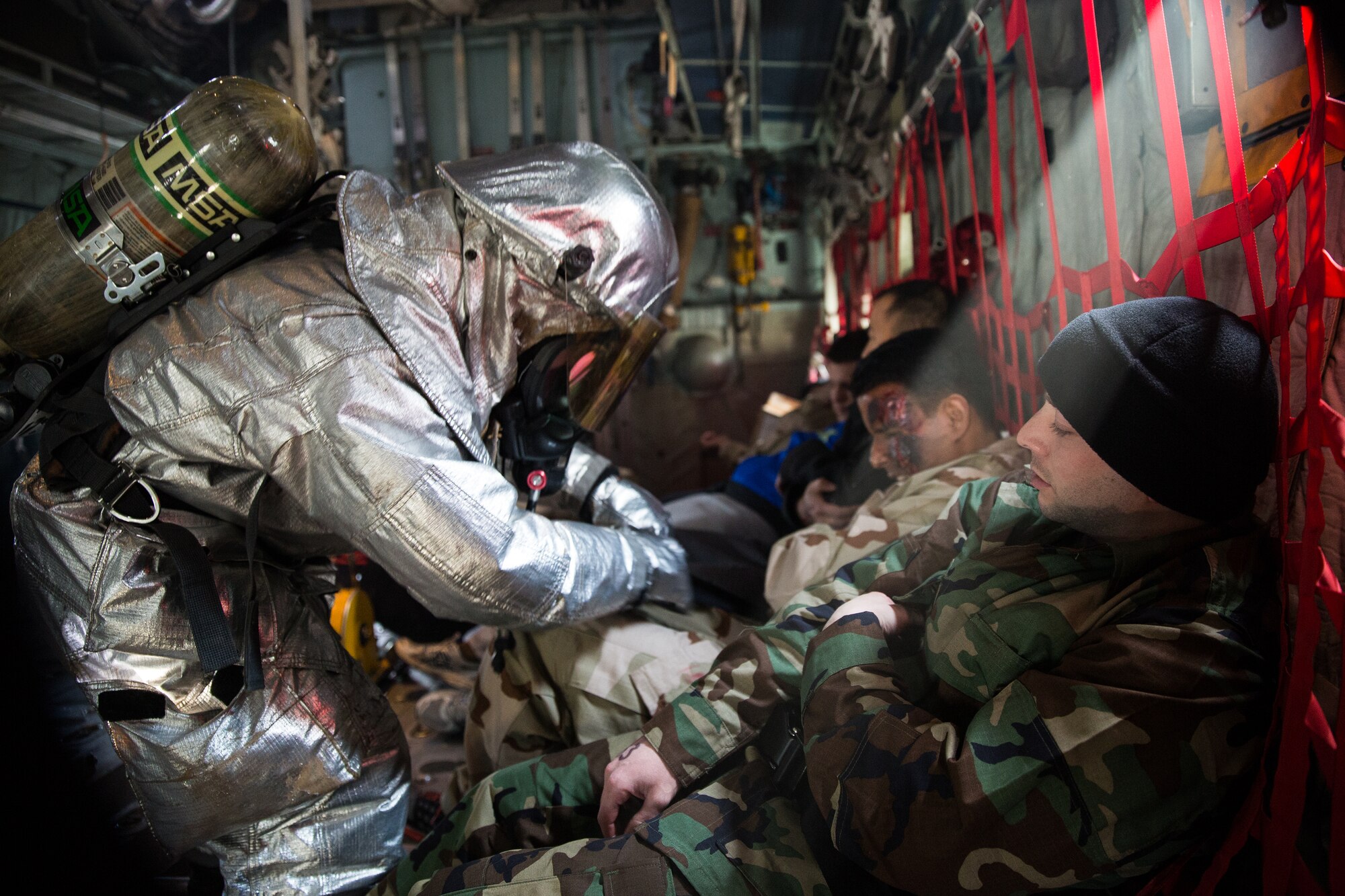 Yokota firefighters arrive on scene and assess simulated injured personnel during a Samurai Readiness Inspection at Yokota Air Base, Japan, March 4, 2014. The readiness inspection was designed to evaluate areas such as rapid mobility response to simulated contingencies and providing airlift support to military and non-combatant evacuation. (U.S. Air Force photo by Osakabe Yasuo/Released)