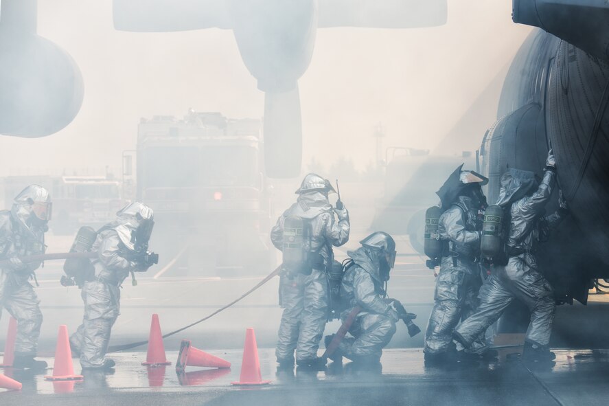 Yokota firefighters prepare to open a door on a simulated downed aircraft during a Samurai Readiness Inspection at Yokota Air Base, Japan, March 4, 2014. The readiness inspection was designed to evaluate areas such as rapid mobility response to simulated contingencies and providing airlift support to military and non-combatant evacuation. (U.S. Air Force photo by Osakabe Yasuo/Released)