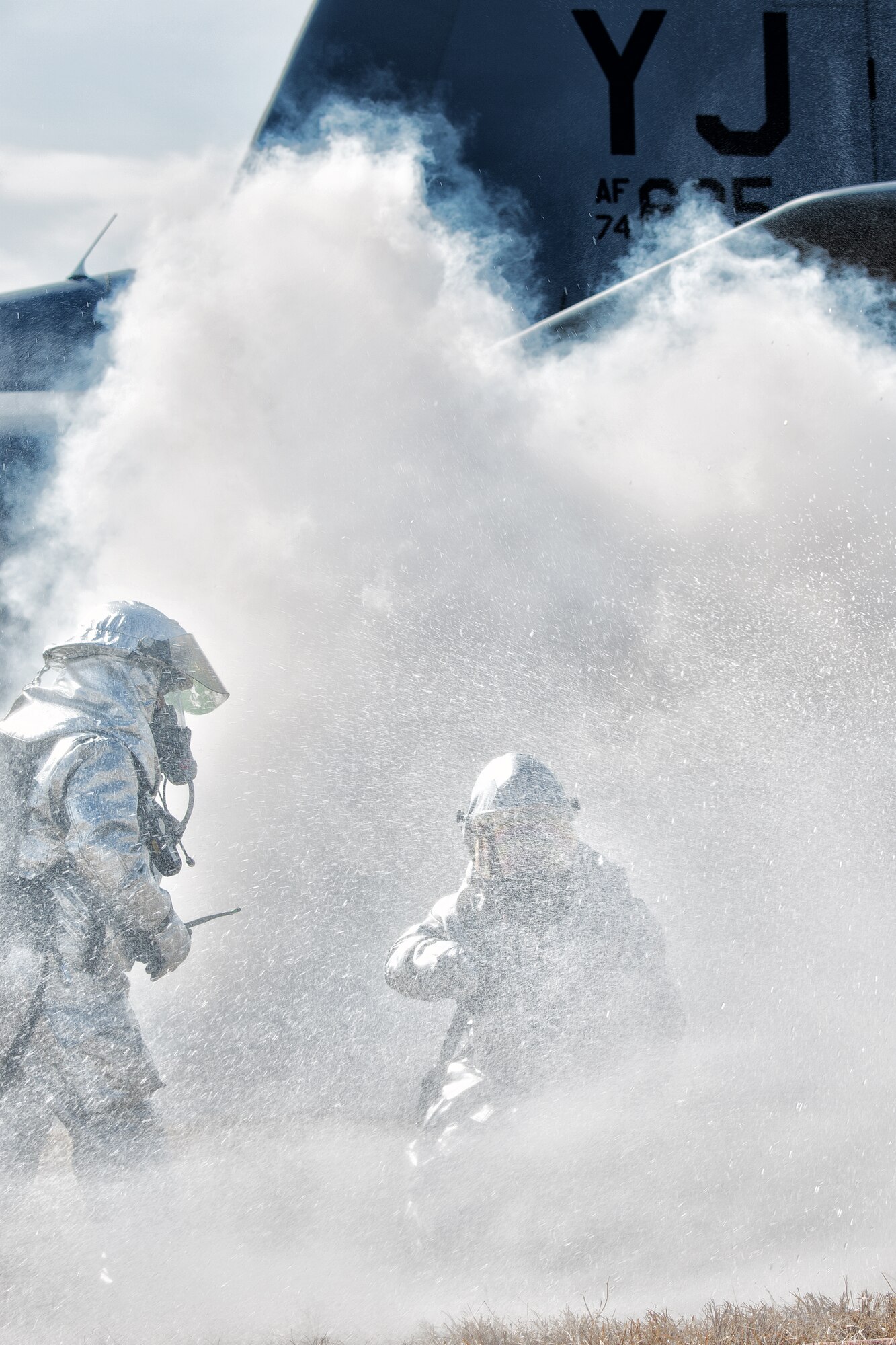 Yokota firefighters arrive on scene and battle a simulated downed aircraft during a Samurai Readiness Inspection at Yokota Air Base, Japan, March 4, 2014. The readiness inspection was designed to evaluate areas such as rapid mobility response to simulated contingencies and providing airlift support to military and non-combatant evacuation. (U.S. Air Force photo by Osakabe Yasuo/Released)