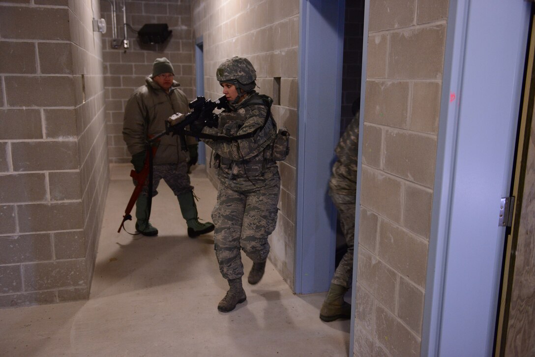 U.S. Air Force Airman 1st Class Lauren Degeberg, 148th Fighter Wing, Duluth, Minn. practices building clearing procedures while in training Feb. 28th, 2014.  148FW Security Forces personnel were at Camp Ripley, Minn. from 27 Feb - 2 March, 2014 to train in combat readiness tasks.  (U.S. Army National Guard photo by Staff Sgt. Anthony A. Housey/Released)