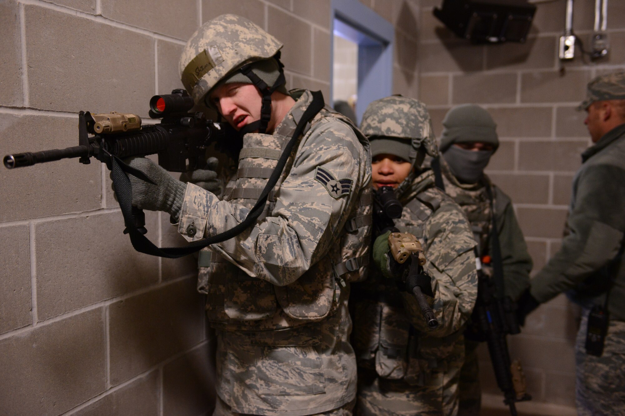 U.S. Air Force Senior Airman Brandon Shimmin and Airman 1st Class Taniya LaJesse, 148th Fighter Wing, Duluth, Minn. practices building clearing procedures while in training Feb. 28th, 2014.  148FW Security Forces personnel were at Camp Ripley, Minn. from 27 Feb - 2 March, 2014 to train in combat readiness tasks.  (U.S. Army National Guard photo by Staff Sgt. Anthony A. Housey/Released)