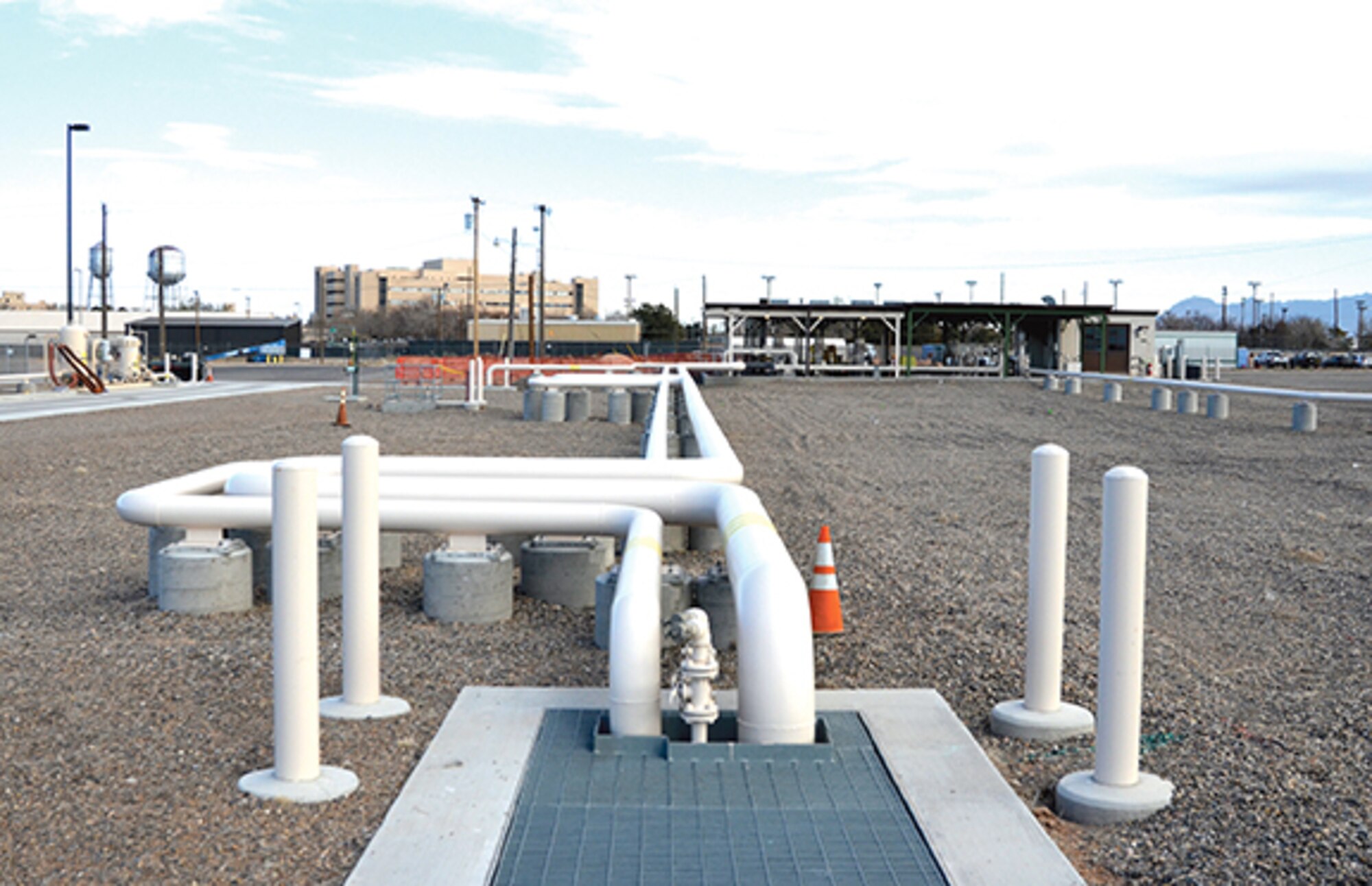 To help prevent spills, all the pipes at the new bulk fuels facility are either above ground or in a concrete-lined trench, where they can be seen through a heavy steel grate. (Photo by Lee Ross)