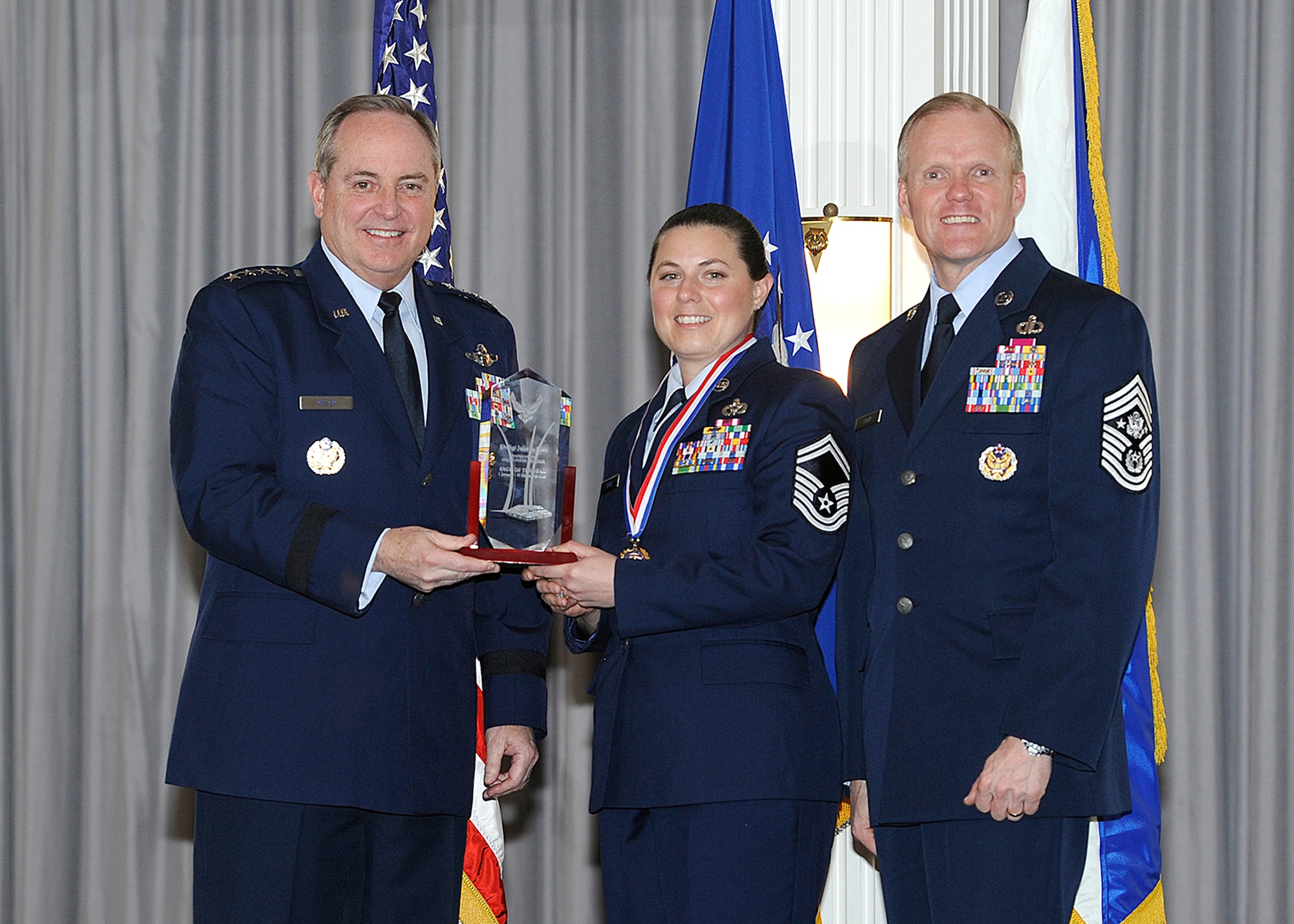 JOINT BASE ANACOSTIA-BOLLING, Washington, D.C. -- Air Force Chief of Staff Gen. Mark A. Welsh III and Chief Master Sgt. of the Air Force James Cody present Senior Master Sgt. Julie Sosa with the Headquarters Air Force 2013 Senior Non-Commissioned Officer of the Year award, during a ceremony held at Joint Base Anacostia-Bolling, Washington, D.C., Feb. 25. Sosa is the operations support program manager at AFCEC. (U.S. Air Force photo/Andy Morataya) 
