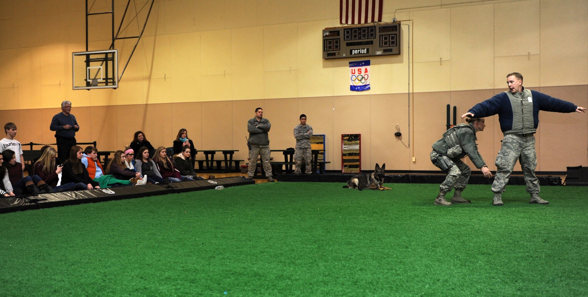 More than 50 Cascade County high school students watch as members of the 341st Security Forces Squadron military working dog section perform a K-9 demonstration at the Malmstrom Fitness Center on Feb. 26. Students had an opportunity to tour Malmstrom Air Force Base and learn about the mission as part of a Leadership High School tour. (U.S. Air Force photo/Senior Airman Katrina Heikkinen)