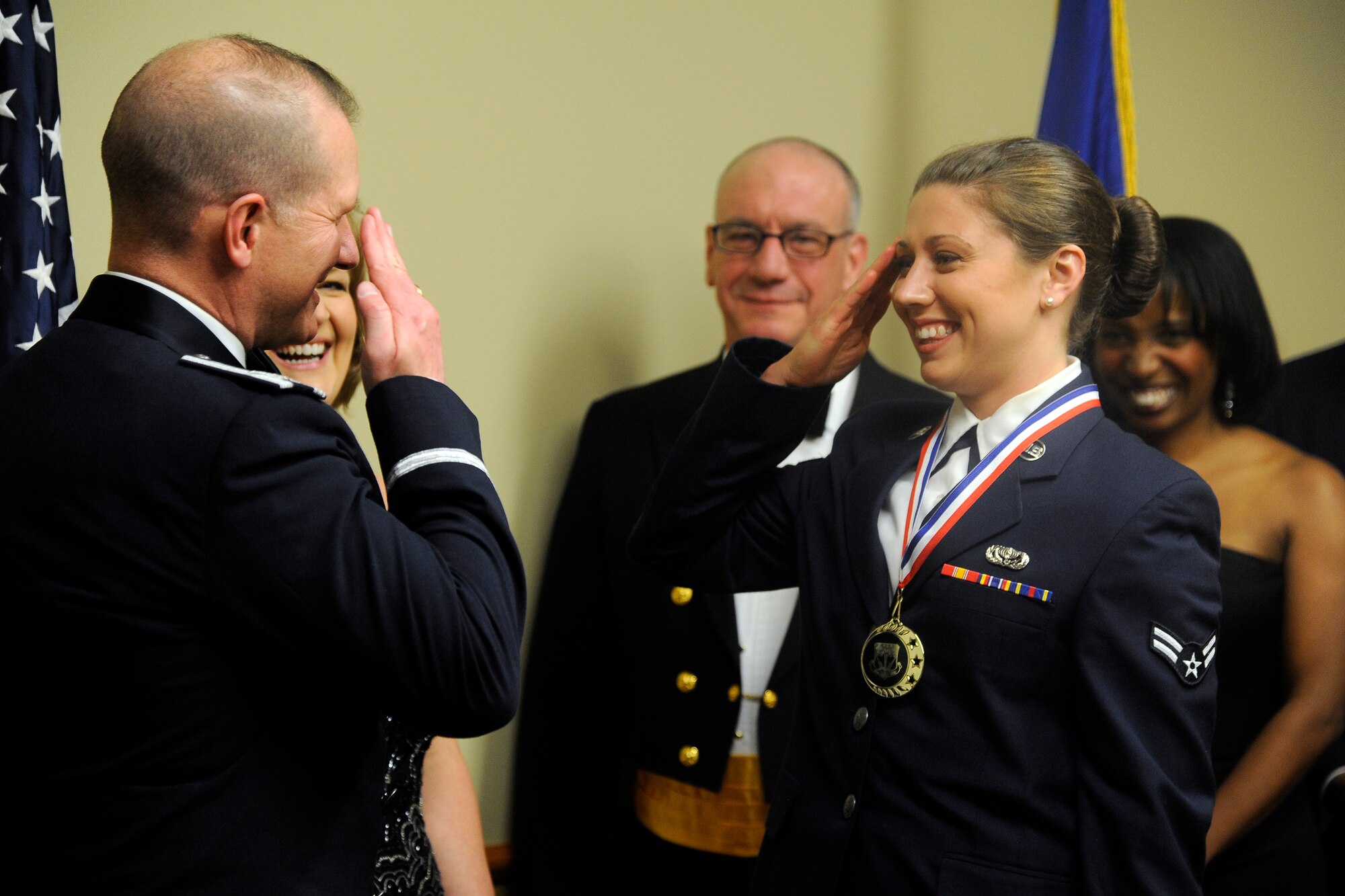 Jennifer Meyer, 341st Contracting Squadron secretary, enters the banquet hall underneath the sabre entrance  with her husband retired Chief Master Sgt. William Meyer at the 2013 Annual Awards Banquet on Feb. 28. Before entering the banquet hall, guests of honor were presented with medallions in recognition of their award nomination. (U.S. Air Force photo/ John Turner)
