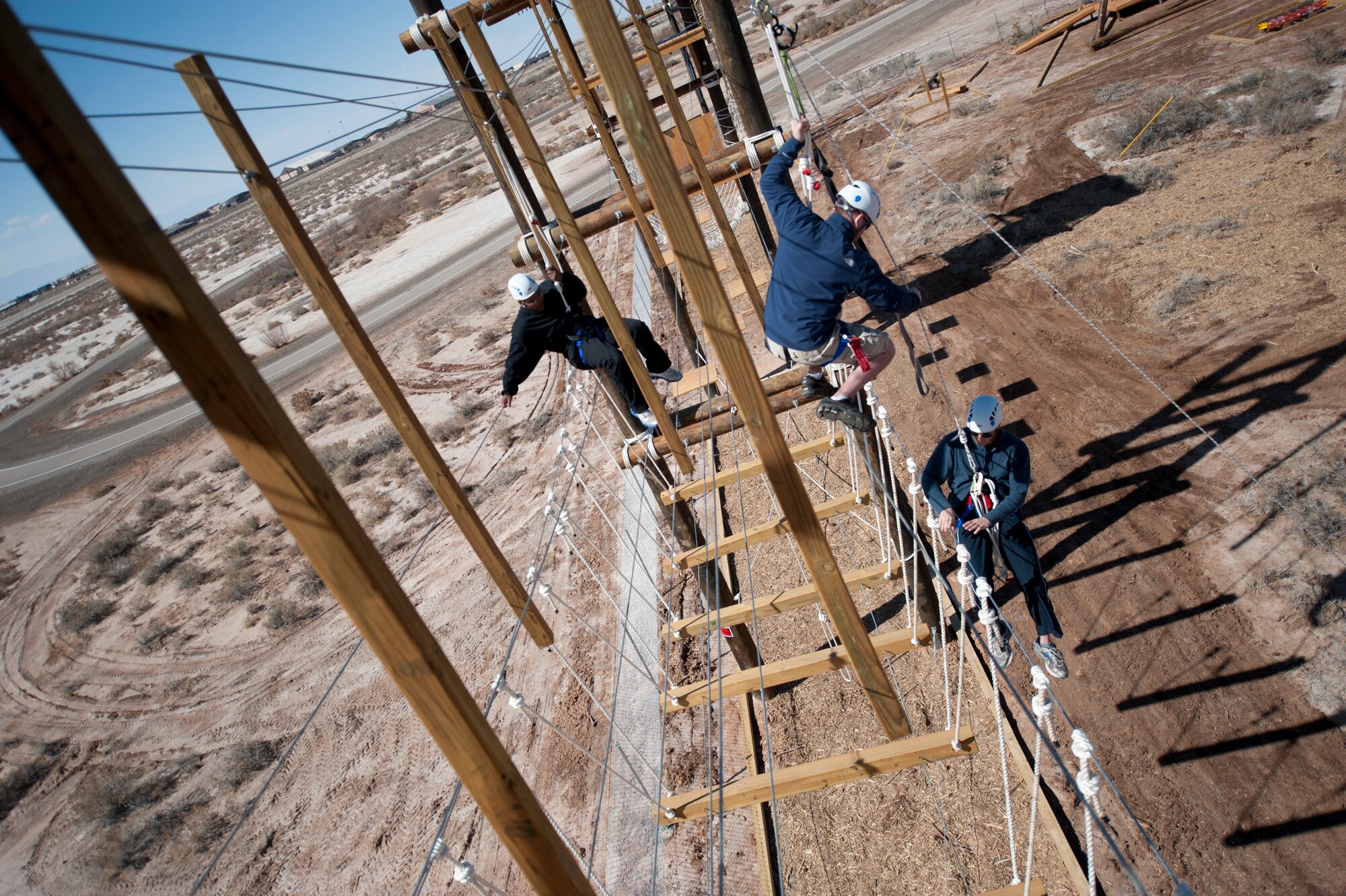 Members of Team Holloman volunteer to be trained as certifiers on the new challenge course at Holloman Air Force Base, N.M., Feb. 28.  The challenge course will be used to implement resiliency training for the First Term Airman Course as well as unit-based training. The volunteers trained using simulated rescue procedures to prepare to be certifiers on the course. (U.S. Air Force photo by Senior Airman Daniel Liddicoet/Released)