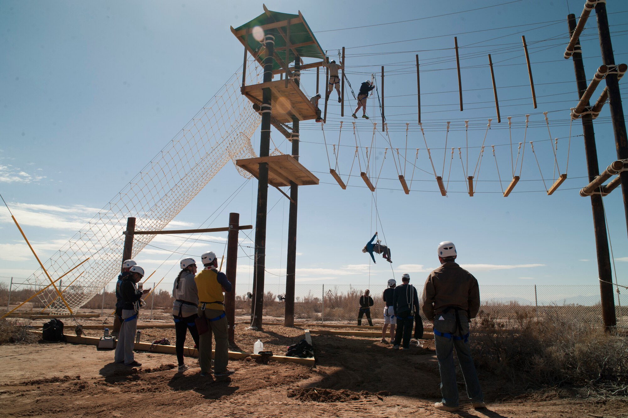 Members of Team Holloman volunteer to be trained as certifiers on the new challenge course at Holloman Air Force Base, N.M., Feb. 28.  The challenge course will be used to implement resiliency training for the First Term Airman Course as well as unit-based training. The volunteers trained using simulated rescue procedures to prepare to be certifiers on the course. (U.S. Air Force photo by Senior Airman Daniel Liddicoet/Released)