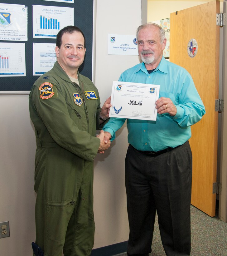 Robert Young, right, 47th Comptroller Squadron Financial Management and Analysis chief, poses with Col. Mark Doria, 47th Flying Training Wing vice commander, after being presented the XLer of the week award here Feb. 19, 2014. The XLer is a weekly award chosen by wing leadership and given to those who consistently make outstanding contributions to Laughlin and their unit. (U.S. Air Force photo/Airman 1st Class Jimmie D. Pike)