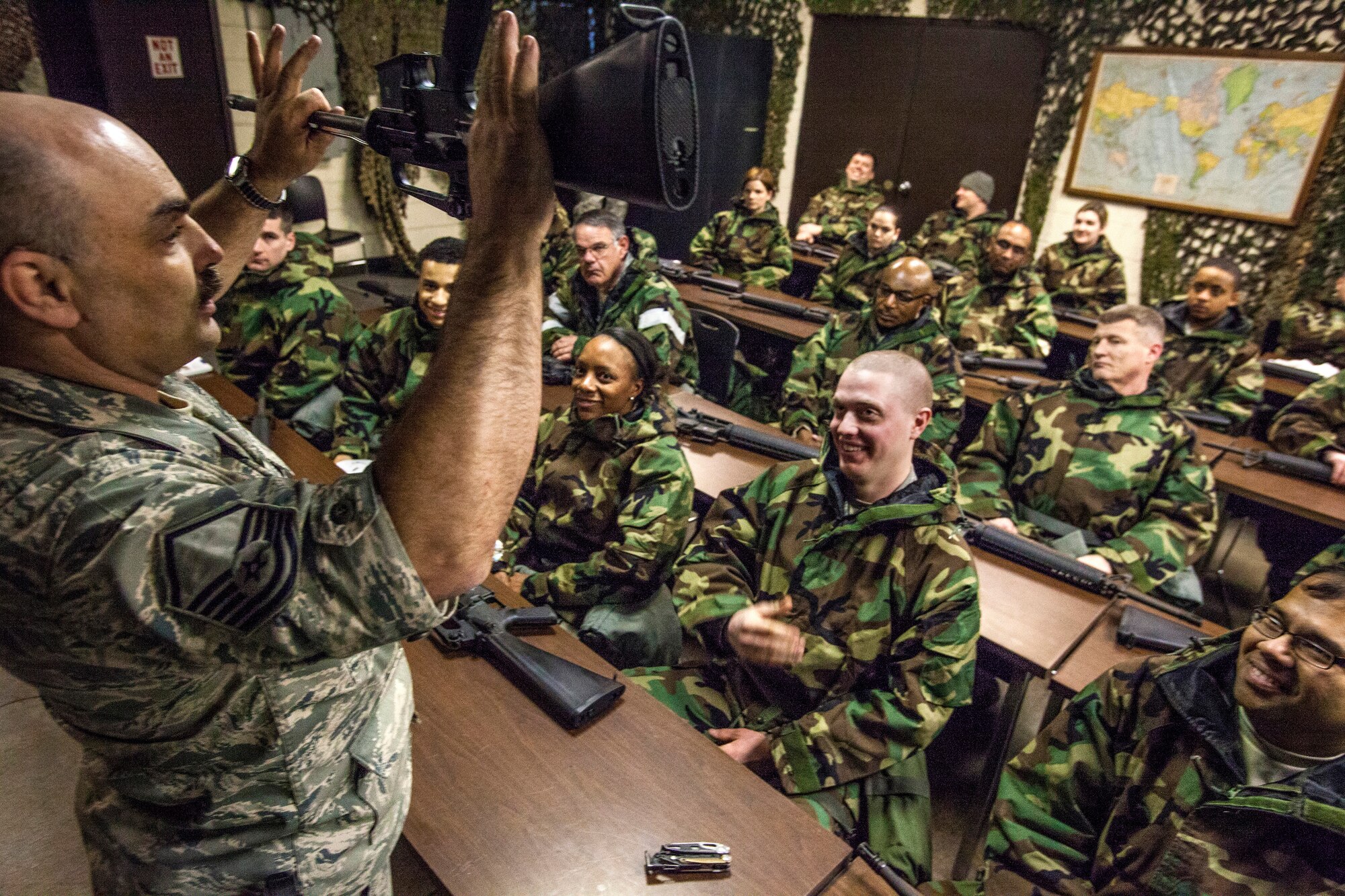 Master Sgt. John N. Charyk, left, instructs Airmen on how to disassemble an M16 rifle as Airmen from the 108th Wing, New Jersey Air National Guard, brush up on their chemical, biological, radiological and nuclear; self-aid buddy care; post attack reconnaissance and disassembling and reassembling Beretta M9 pistol and M16 rifle skills during the Wing’s Ability to Survive and Operate Rodeo at Joint Base McGuire-Dix-Lakehurst, N.J. Feb. 9, 2014. The Wing-level evaluation shows what training areas need more focus. ATSO is used by Airmen who are deploying or preparing for exercises or inspections. These skills make up the foundation necessary for all Airmen to function effectively in hostile environments. (U.S. Air National Guard photo by Master Sgt. Mark C. Olsen/Released)