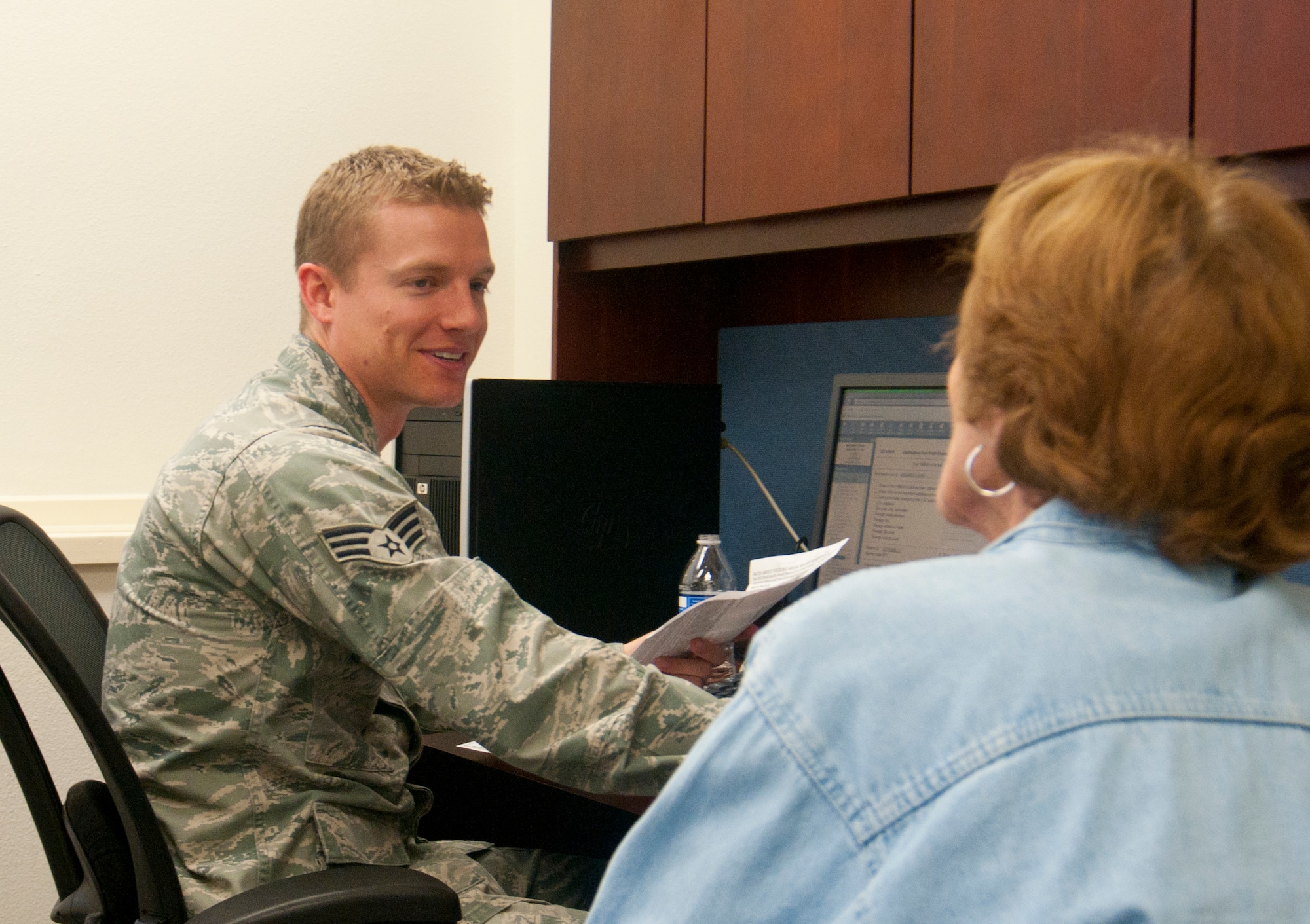 Senior Airman Paul Wilke, 90th Contracting Squadron contract specialist and F.E. Warren Air Force Base, Wyo., Tax Center volunteer, helps a client file her 2013 taxes in the tax center March 4, 2014. Volunteers take a week-long class teaching them the ins and outs of tax preparation before helping people in the tax center. People with base access can schedule a time to receive tax help from volunteers and 90th Missile Wing Judge Advocate personnel by calling 773-5829. (U.S. Air Force photo by Airman 1st Class Jason Wiese)