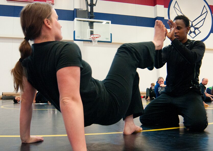 Senior Airman Ashley Kuklinski, 90th Security Support Squadron, and Airman 1st Class Jennifer Ligali, 90th Force Support Squadron personnelist, work together to improve the techniques they learned during the Gracie Defense Systems training course for Airmen at F.E. Warren Air Force Base, Wyo., in the Freedom Hall Fitness Center Feb. 28, 2014. (U.S. Air Force photo by Airman 1st Class Jason Wiese)