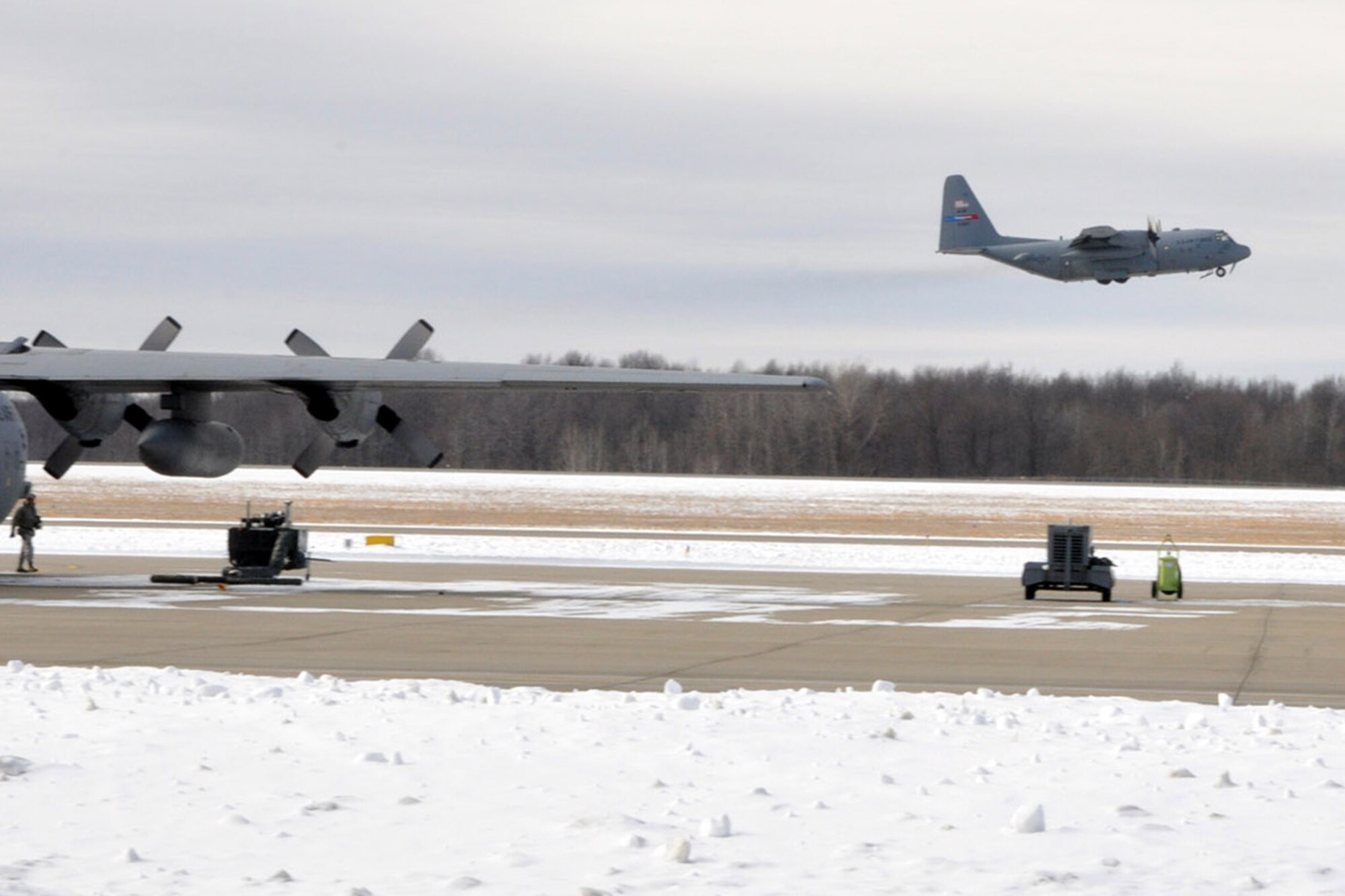 YOUNGSTOWN AIR RESERVE STATION, Ohio – An Air Force Reserve C-130 Hercules cargo aircraft, 910th Airlift Wing Tail 3021, takes off into a Northeast Ohio winter sky, departing here for the final time, March 5, 2014. The aircraft is being transferred to Little Rock Air Force Base, Ark. as part of recent Air Force structure changes. The departure of 3021 from YARS leaves the 910th with eight primary C-130 aircraft and one back up aircraft assigned to the unit. U.S. Air Force photo by Master Sgt. Bob Barko Jr.