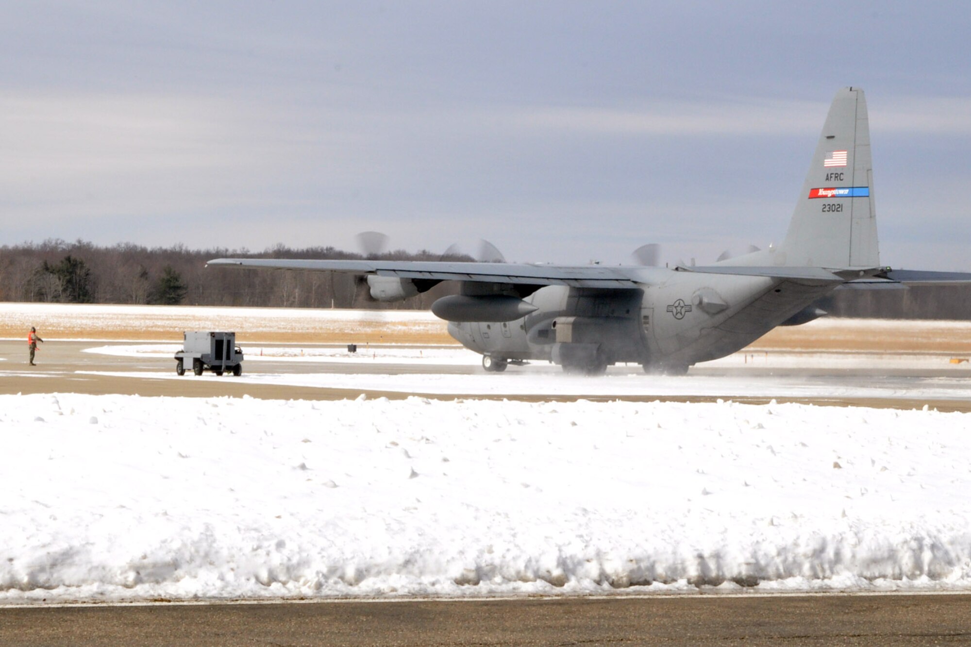 YOUNGSTOWN AIR RESERVE STATION, Ohio – Air Force Reserve C-130 Hercules cargo aircraft, 910th Airlift Wing Tail 3021, sits on the air station flightline as aircrew and ground support personnel prepare it to depart here for the final time, March 5, 2014. The aircraft is being transferred to Little Rock Air Force Base, Ark. as part of recent Air Force structure changes. The departure of 3021 from YARS leaves the 910th with eight primary C-130 aircraft and one back up aircraft assigned to the unit. U.S. Air Force photo by Master Sgt. Bob Barko Jr.