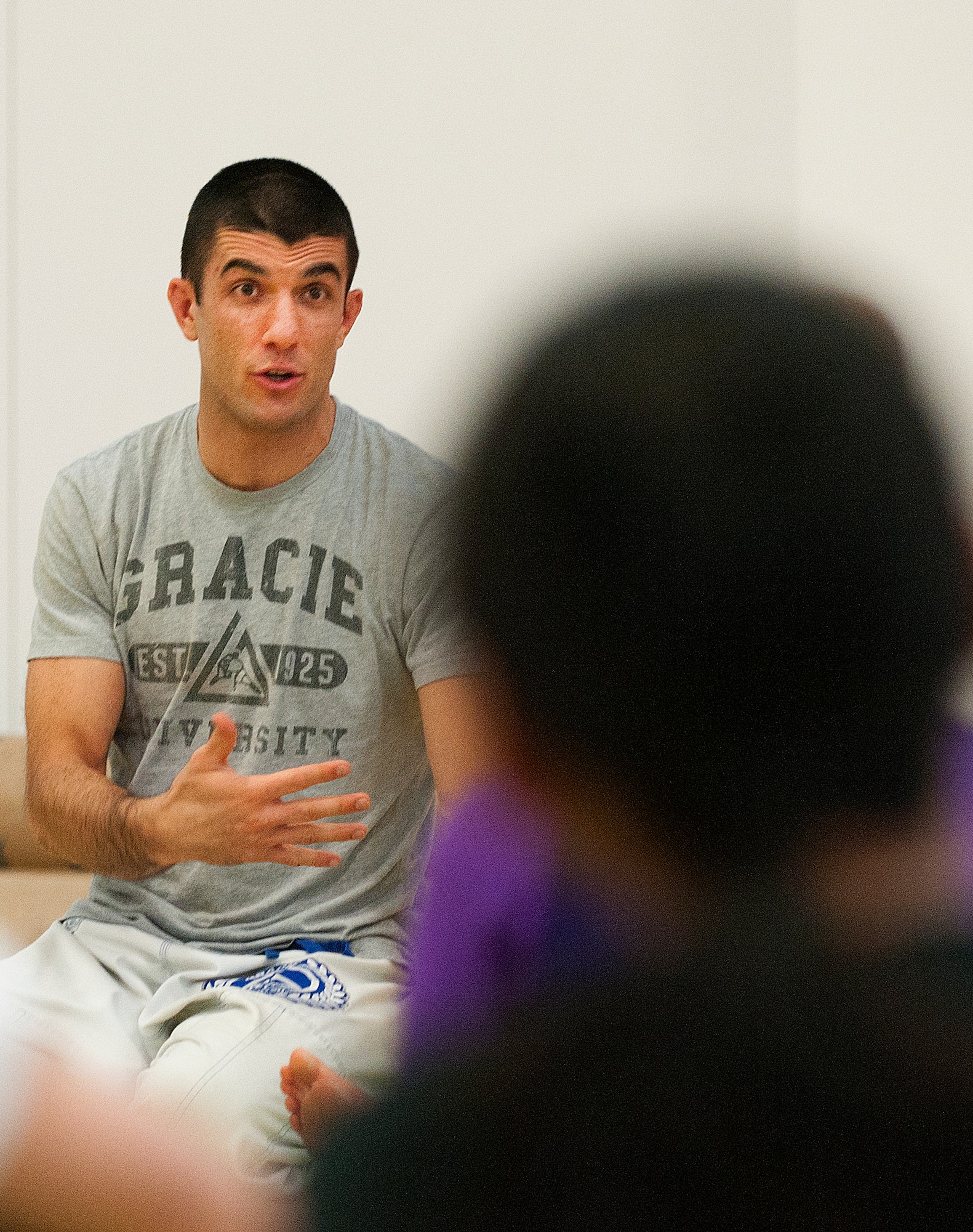 Rener Gracie, head instructor of the Gracie Jiu Jitsu Academy based out of Torrance, Calif., teaches Airmen and their spouses concepts of Gracie Defense Systems, a method avoiding assaults and preventing potential attacks through assertiveness and confidence with roots in martial arts, specifically Jiu Jitsu, in the Freedom Hall Fitness Center Feb. 27, 2014. (U.S. Air Force photo by R.J. Oriez)