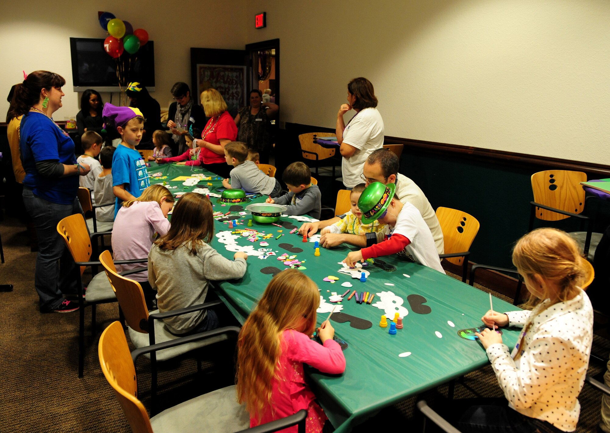 Children of deployed Airmen work at an arts & crafts section during a Hearts Apart Dinner at the Recce Point Club on Beale Air Force Base, Calif., March 3, 2014. Hearts Apart Dinners bring families of deployed Airmen together. (U.S. Air Force photo by Airman 1st Class Bobby Cummings/ Released)