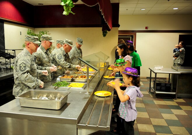 Some of Beale’s First Sergeants serve meals to families of deployed Airmen at a Hearts Apart Dinner at the Recce Point Club on Beale Air Force Base, Calif., March 3, 2014. Hearts Apart Dinners bring families of deployed Airmen together. (U.S. Air Force photo by Airman 1st Class Bobby Cummings/ Released)