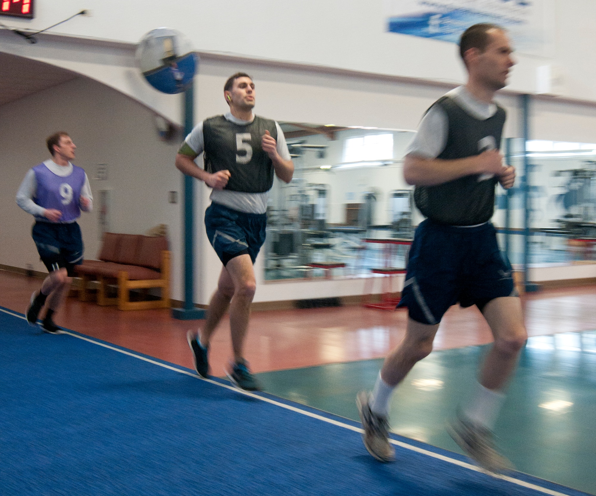 Airmen run the track in the Independence Hall Fitness Center on F.E. Warren Air Force Base, Wyo., March 4, 2014, during the timed run portion of their Air Force fitness assessment. The timed run, which accounts for 60 percent of the possible points Airmen can score on the assessment, is the portion of the assessment with which most Airmen struggle. The 90th Force Support Squadron Fitness Improvement Program aims to help Airmen improve their assessment scores, so cardio training is an important part of the program, which will help Airmen score higher on the timed run portion of the test. (U.S. Air Force photo by Airman 1st Class Jason Wiese)