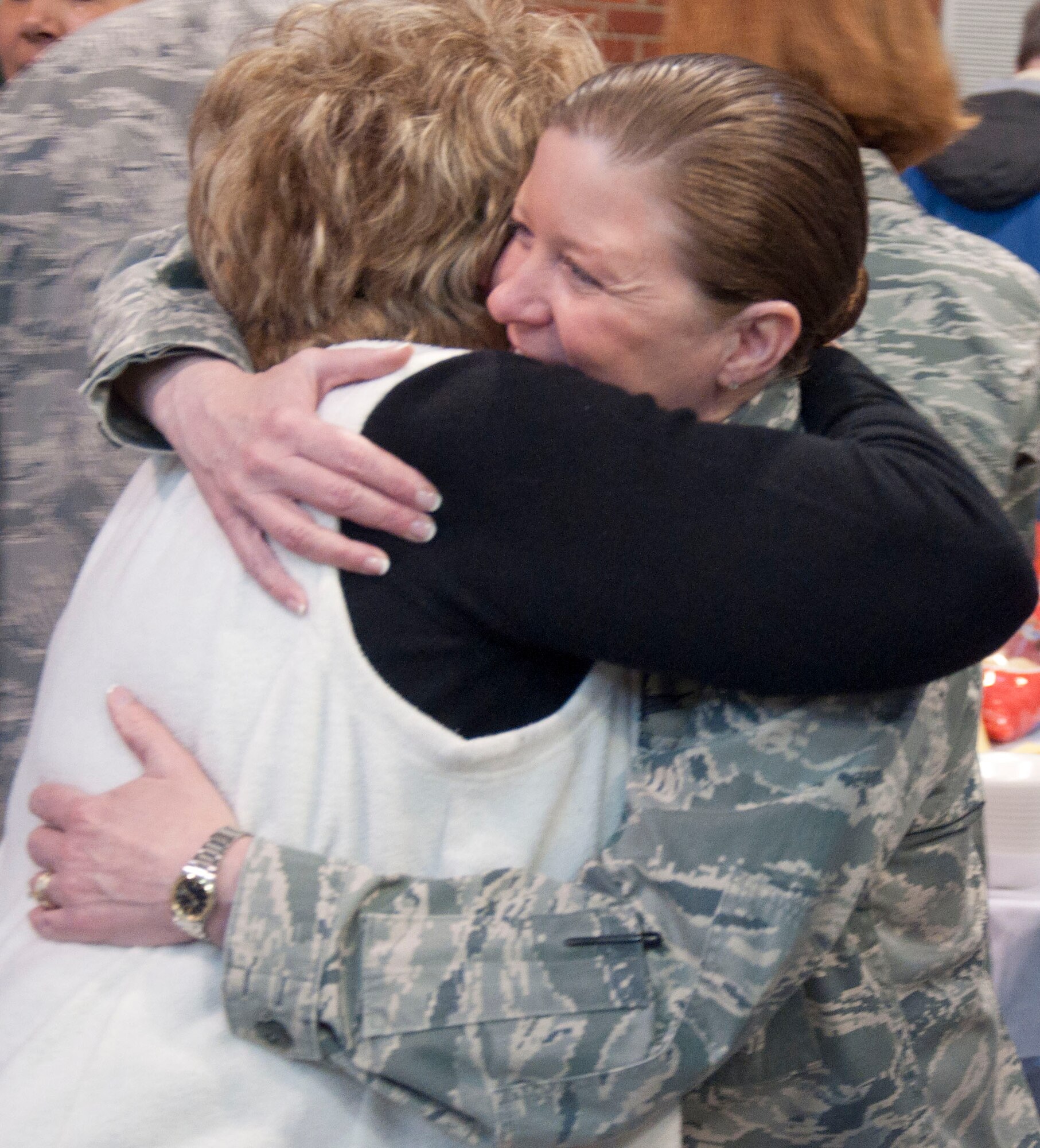 140304-F-GZ967-058 Col. Tracey Hayes, 90th Missile Wing commander, embraces Barb Lutz, secretary and chief of protocol for the 20th Air Force commander, during a surprise celebration honoring her 40 years of service March 4 in the Fall Hall Community Center. Attendees formed a line to congratulate Lutz on reaching the milestone and thanked her for her commitment to service. (U.S. Air Force photo by Airman 1st Class Brandon Valle)
