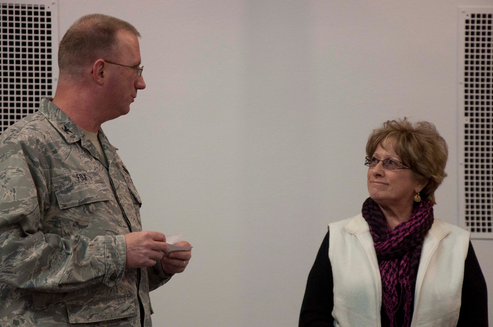 140304-F-GZ967-016 Col. Scott Fox, 20th Air Force vice commander, recognizes the 40 years of dedication and hard work of Barb Lutz, secretary and chief protocol for the 20th Air Force commander, March 4 in the Fall Hall Community Center. In Fox’s remarks, he noted that her annual appraisals were filled with accolades from her past supervisors – things like “outshines her peers” and “there isn’t a better chief of protocol or protocol officer than Barb.” (U.S. Air Force photo by Airman 1st Class Brandon Valle)