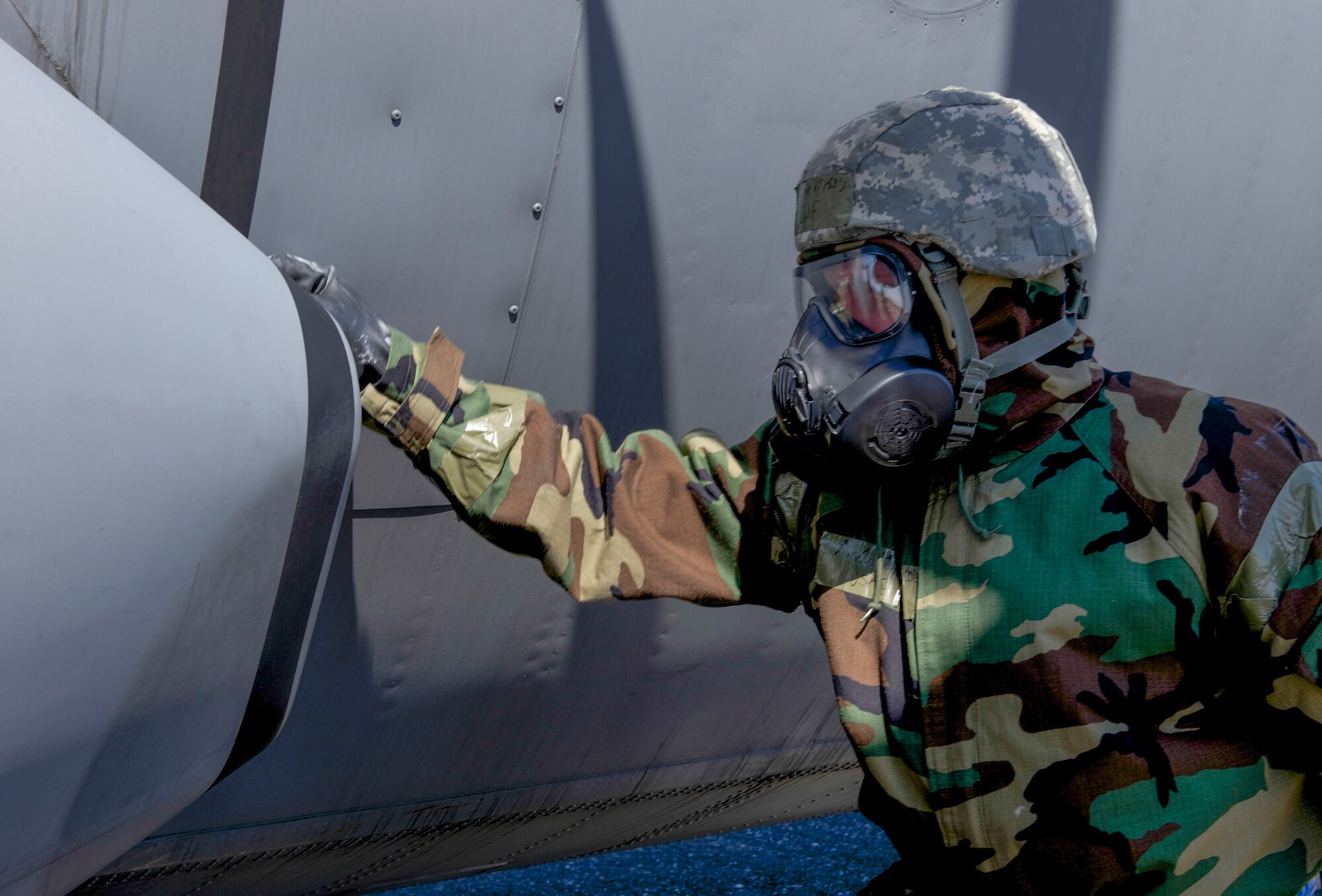 A1C Timothy Kidd, 374th Aircraft Maintenance Squadron test for contamination on a C-130 Hercules during the Samurai Readiness Inspection at Yokota Air Base, Japan, March 6, 2014. Yokota is continuing their week-long Samurai Readiness Inspection, where they are being tested to perform under the challenging scenarios such as a chemical warfare attack. (U.S. Air Force photo by Airman 1st Class David Danford / released)