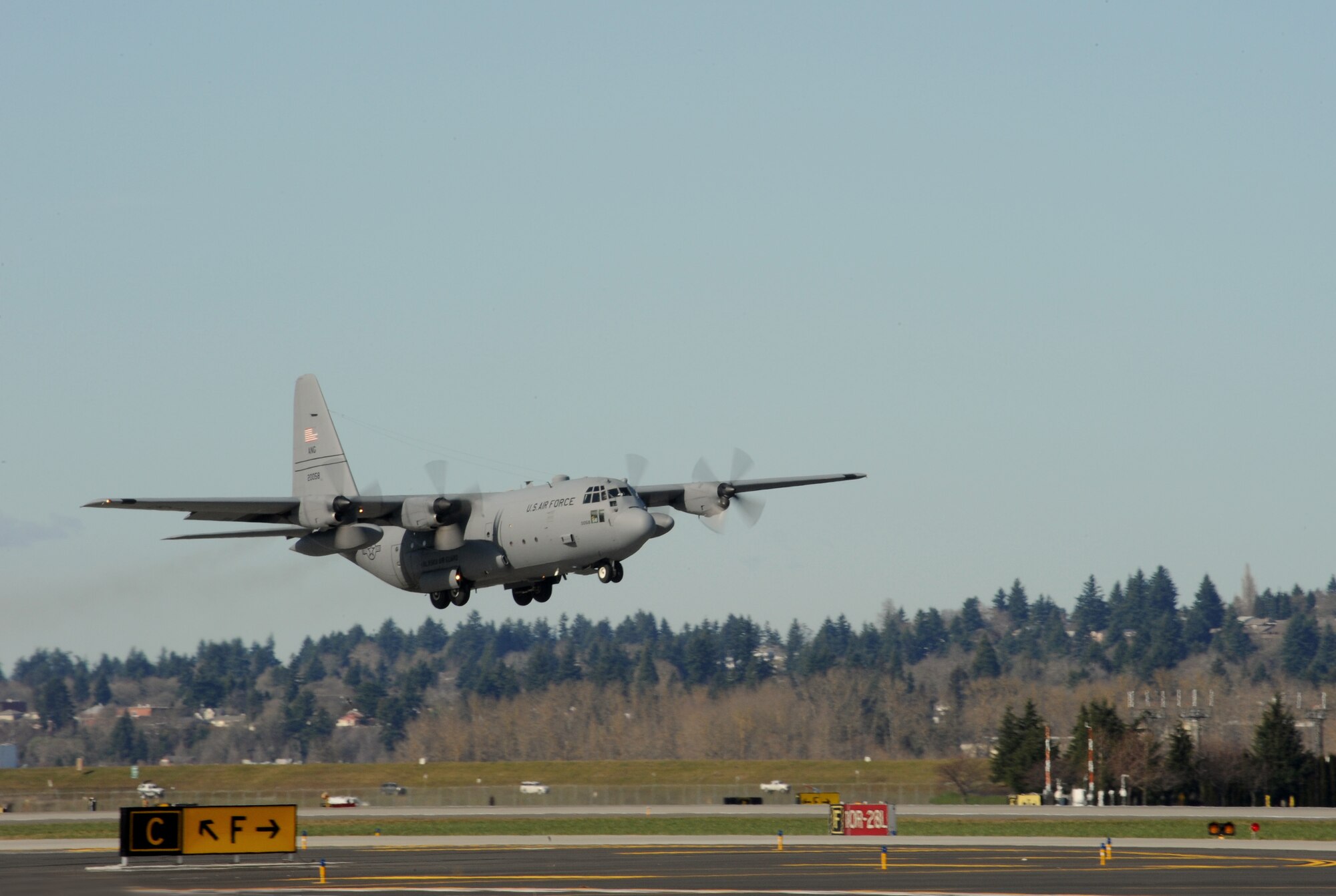 An Alaska Air National Guard C-130 Hercules aircraft leaves the Portland Air National Guard Base, Ore., prior to departing for Nellis Air Force Base, Nev., Feb. 28, 2014. (U.S. Air National Guard photo by Tech. Sgt. John Hughel/Released)