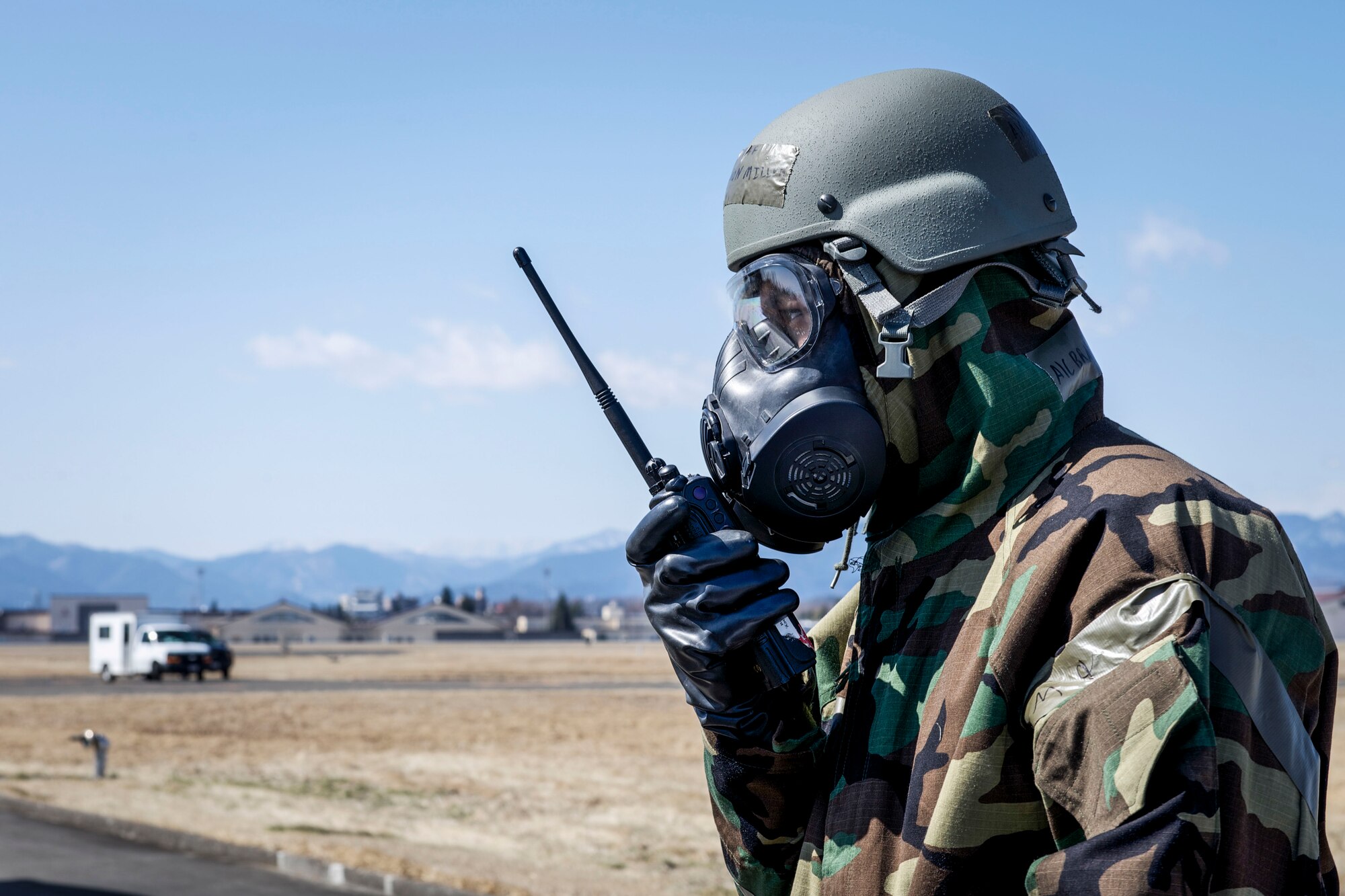 Airman 1st Class Brandon Miller, 374th Civil Engineer Squadron uses a radio wearing his mission-oriented protective posture gear at Yokota Air Base, Japan, March 6, 2014. Yokota is continuing their week-long Samurai Readiness Inspection, where they are being tested to perform under the challenging scenarios such as a chemical warfare attack. (U.S. Air Force photo by Airman 1st Class David Danford / released)