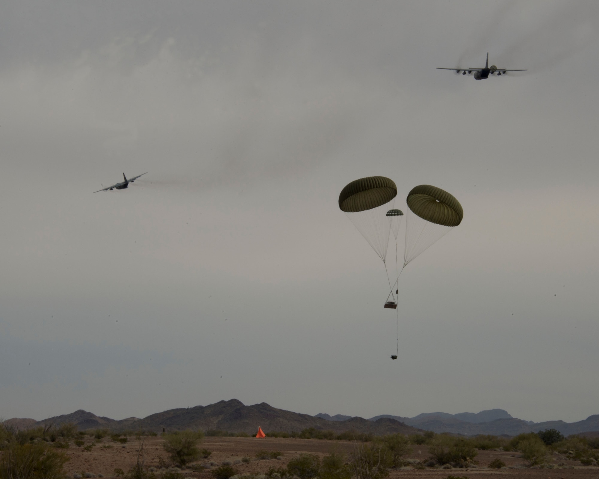 Airmen from the 109th Airlift Squadron conduct a low-cost, low-altitude airdrop in Yuma, Ariz. Feb., 25, 2014. The Airmen are making use of the warm climate to accomplish six-months of airdrops and other annual training requirements in a six-day time period.
(U.S. Air National Guard photo Tech. Sgt. Amy M. Lovgren/ Released) 

