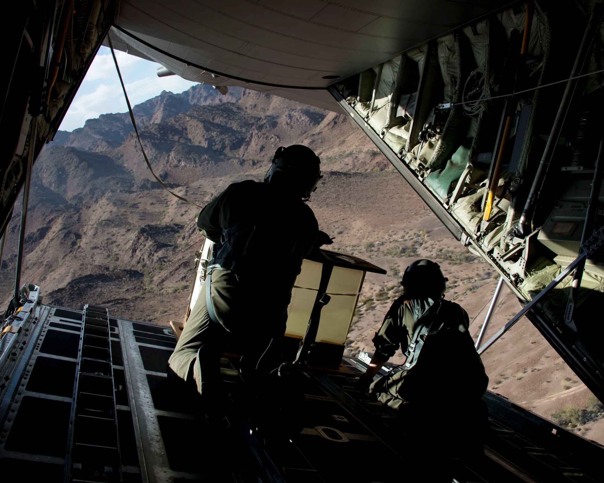 Senior Master Sgt. Mark Norman, left, and Senior Airman Sam Leebens, loadmasters with the 109th Airlift Squadron wait to release a pallet during a low-cost, low-altitude airdrop in Yuma, Ariz., Feb. 24, 2014. Loadmasters oversee the release of the cargo during the airdrop. 
(U.S. Air National Guard photo by Tech. Sgt. Amy M. Lovgren/ Released)