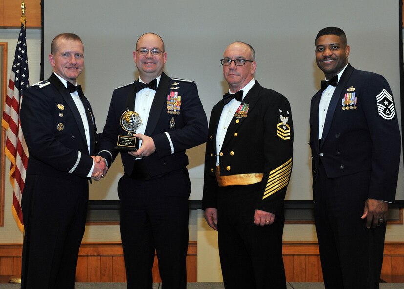 The 341st Missile Wing’s command post was named Malmstrom Air Force Base's Professional Team of the Year for 2013.  Shown accepting the award is Lt. Col. David Mattson, chief of the command post, second from left. Shown presenting the award are Col. Robert W. Stanley II, 341 MW commander; Master Chief Kevin F. Staub, Submarine Group 9 command master chief; and Chief Master Sgt. Phillip L. Easton, 341 MW command chief.  The presentation was made at the annual awards banquet held Feb. 28 at the Grizzly Bend.  (U.S. Air Force photo/ John Turner)