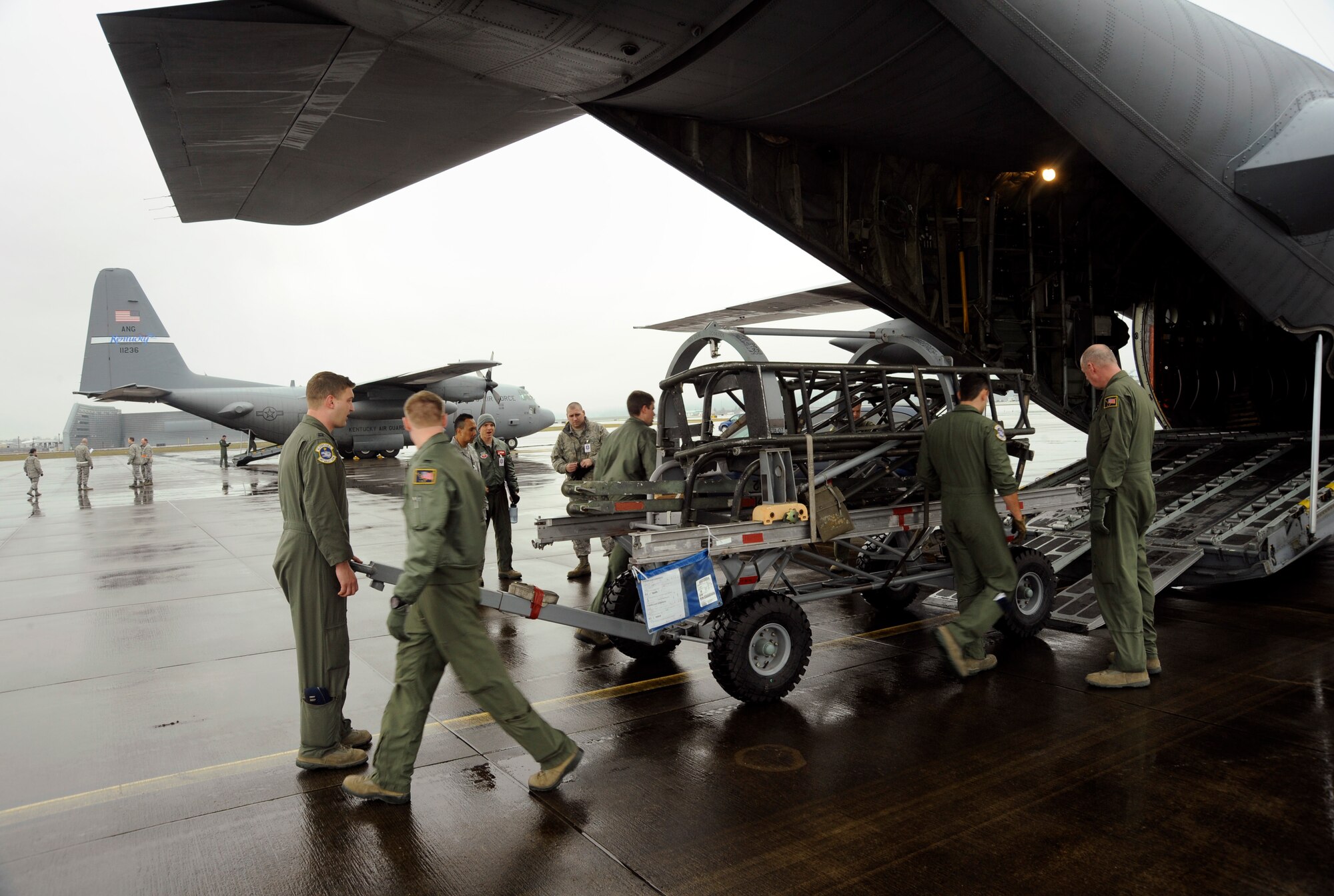 Oregon Air National Guard Logistical Readiness Squadron members from the 142nd Fighter Wing, load cargo into a C-130 Hercules, at the Portland Air National Guard Base, Ore., Feb. 27, 2014. (U.S. Air National Guard photo by Tech. Sgt. John Hughel/Released)