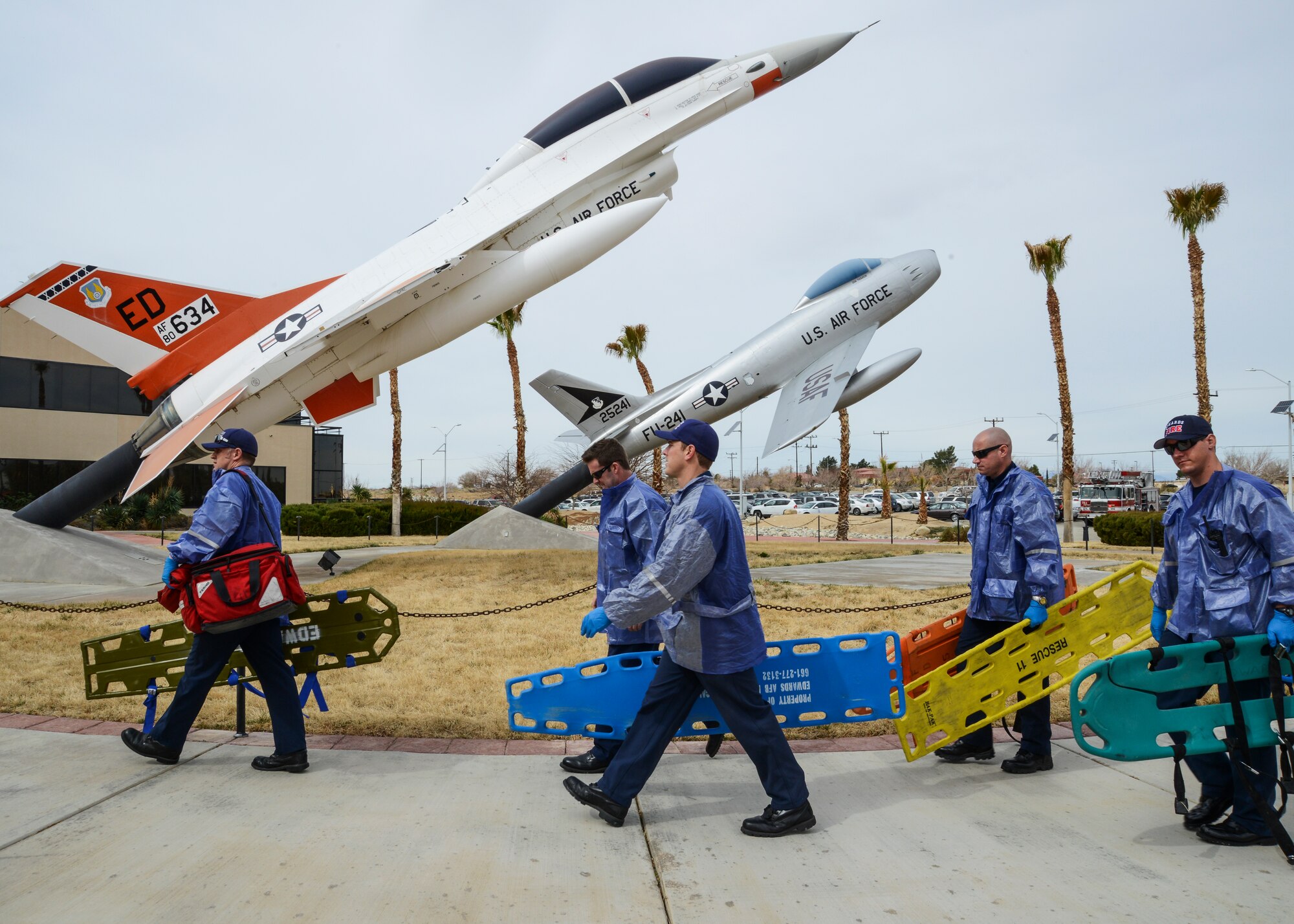 Members of the Edwards AFB Fire Department make their way to the entrance to 412th Test Wing Headquarters to treat victims of an active shooter. The exercise was designed to test and train the base's response to an active shooter scenario. (U.S. Air Force photo by Rebecca Amber)