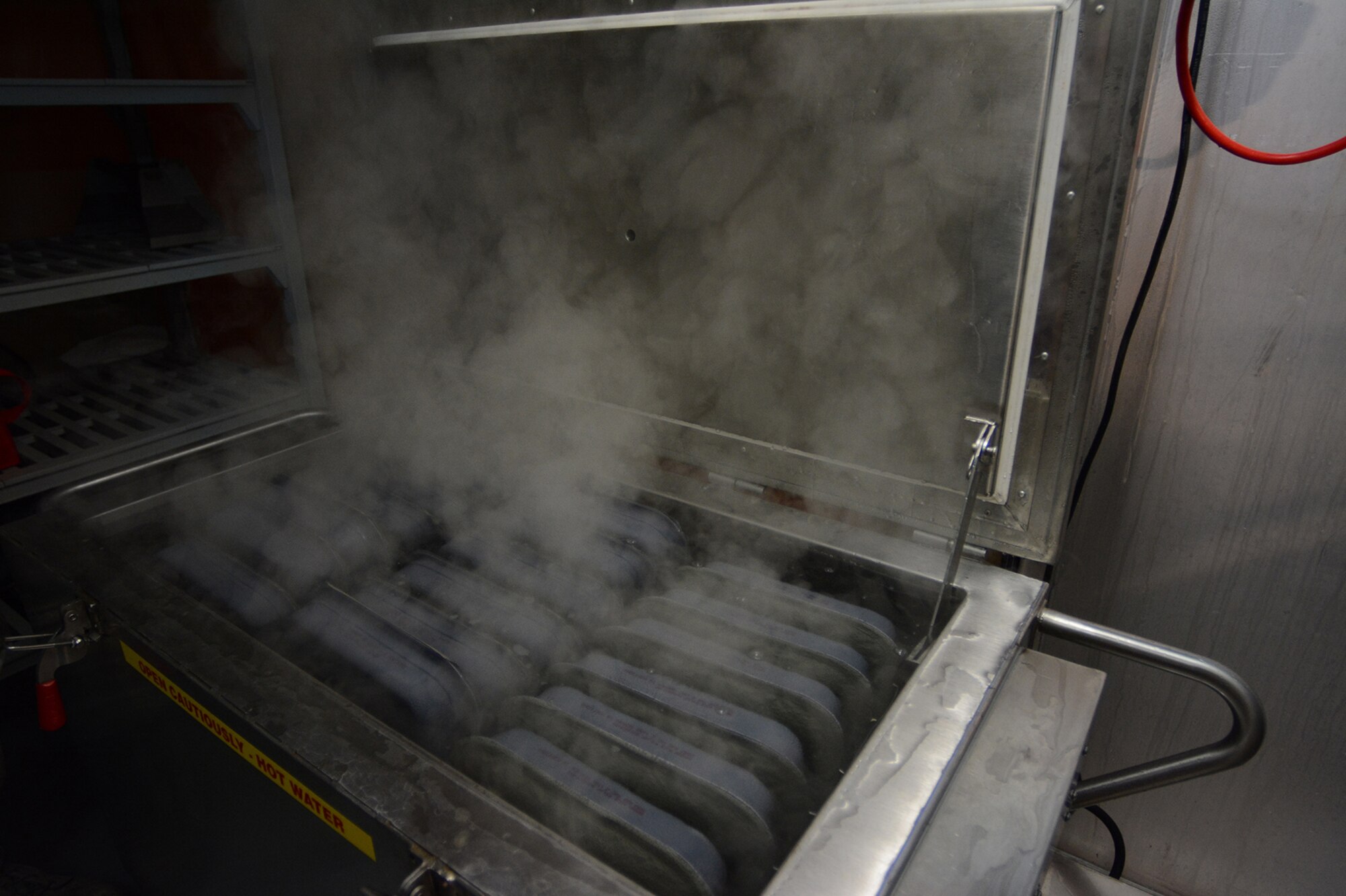 Food cooks in the Single Pallet Expeditionary Kitchen using boiling water during Cajun Care 2014 in Abbeville, La., March 4, 2014. The 115th Force Support Squadron services Airmen prepared food using the SPEK every day during the 10-day mission. (Air National Guard photo by Senior Airman Andrea F. Liechti)