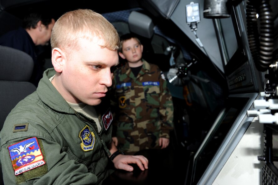 1st Lt. Ryan Cobb, 384th Air Refueling Squadron navigator, demonstrates his job on KC-135 Stratotankers to Civil Air Patrol cadets March 3, 2014, at McConnell Air Force Base, Kan. CAP cadets visited the KC-135 Stratotanker simulator and refueled different planes using the KC-135 Boom Operator Weapon System Trainer. (U.S. Air Force photo/Airman 1st Class David Bernal Del Agua)   