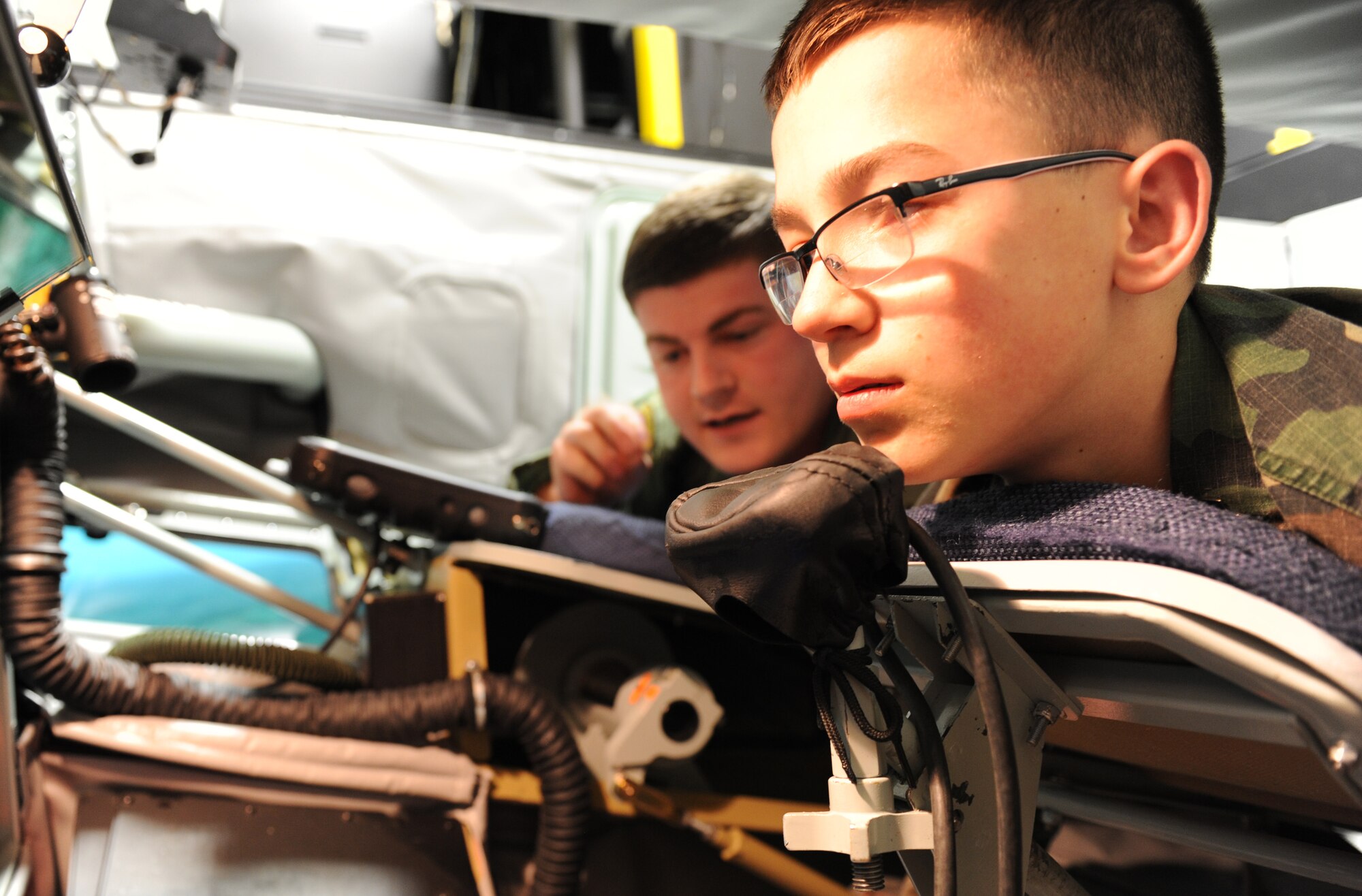 Senior Airman Mike Voorhees, 349th Air Refueling Squadron boom operator instructor, teaches a Civil Air Patrol cadet about the duties of boom operators March 3, 2014, at McConnell Air Force Base, Kan. CAP cadets visited the KC-135 Stratotanker simulator and refueled different planes using the KC-135 Boom Operator Weapon System Trainer. (U.S. Air Force photo/Airman 1st Class David Bernal Del Agua)