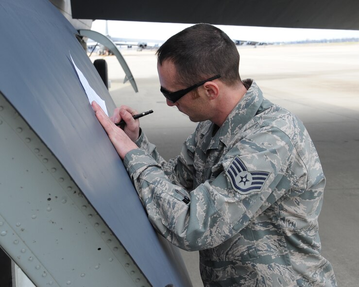 Staff Sgt. Michael Todaro, 2nd Aircraft Maintenance Squadron dedicated crew chief, fills out a form prior to a takeoff on Barksdale Air Force Base, La., Mar 4, 2014. Todaro was selected for a crew chief position on Air Force 2 at Andrew Air Force Base, Md. The form is used to (U.S. Air Force photo/Staff Sgt. Sean Martin)