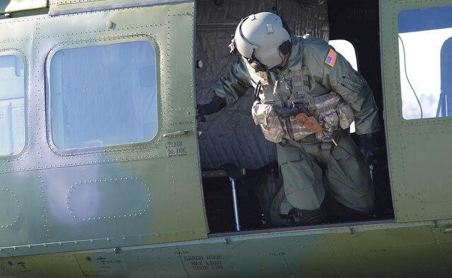 Tech. Sgt. Tim McKinley, 54th Helicopter Squadron flight engineer, checks the side of the UH-N1 helicopter just before takeoff from Minot Air Force Base, N.D., Feb. 21, 2014. Part of the takeoff procedure is for the flight engineer to check the area surrounding the helicopter to ensure there are no individuals near it. (U.S. Air Force photo/Senior Airman Andrew Crawford)