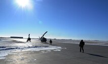 Tech. Sgt. Tim McKinley, 54th Helicopter Squadron flight engineer, walks toward his UH-N1 helicopter to prepare for takeoff at Minot Air Force Base, N.D., Feb. 21, 2014. McKinley provides information and data to the flight crew during a briefing and also ensures the safety of the helicopter during pre-flight checks. (U.S. Air Force photo/Senior Airman Andrew Crawford)