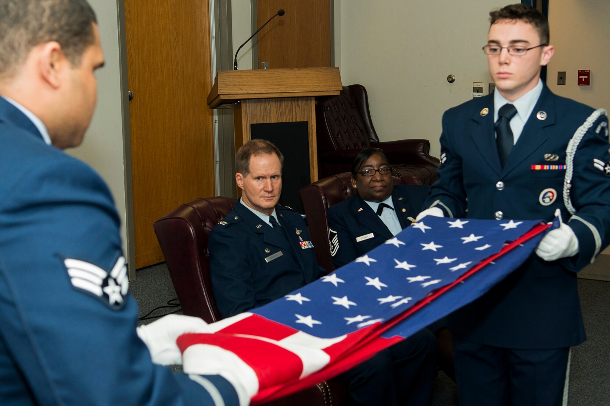 Members of the Barksdale Honor Guard fold an American Flag during the retirement ceremony for U.S. Air Force Master Sgt. Debra Phenix, Mar. 2, 2014, Barksdale Air Force Base, La. The flag folding is a common part of a military retirement and once the folding is complete, an Honor Guard member presents the flag to the retiree. (U.S. Air Force photo by Master Sgt. Greg Steele/Released)