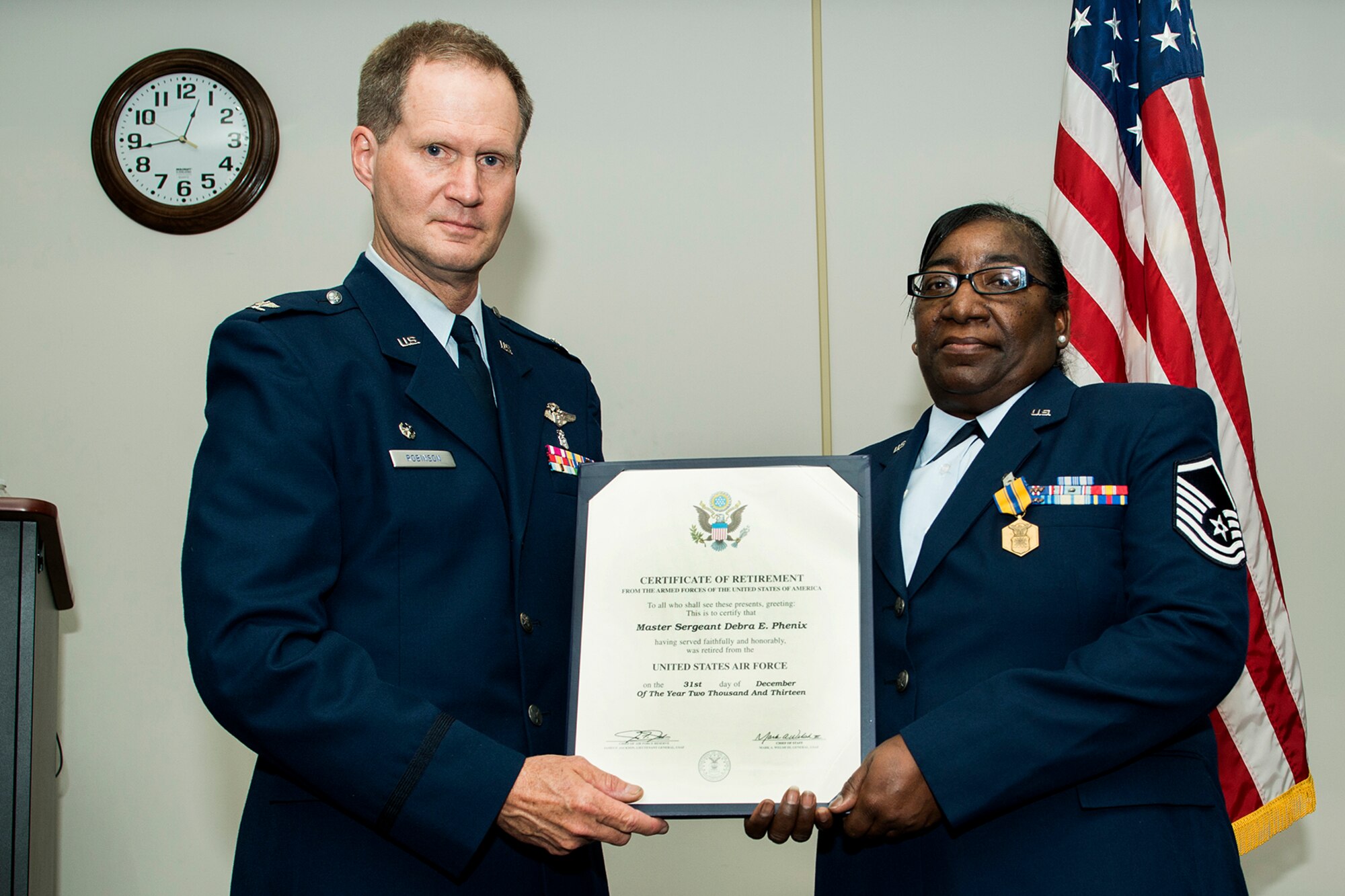 The Certificate of Retirement is presented to U.S. Air Force Master Sgt. Debra Phenix, Mar. 2, 2014, Barksdale Air Force Base, La. Phenix is assigned to the 307th Medical Squadron and is retiring from the Air Force Reserve. (U.S. Air Force photo by Master Sgt. Greg Steele/Released)