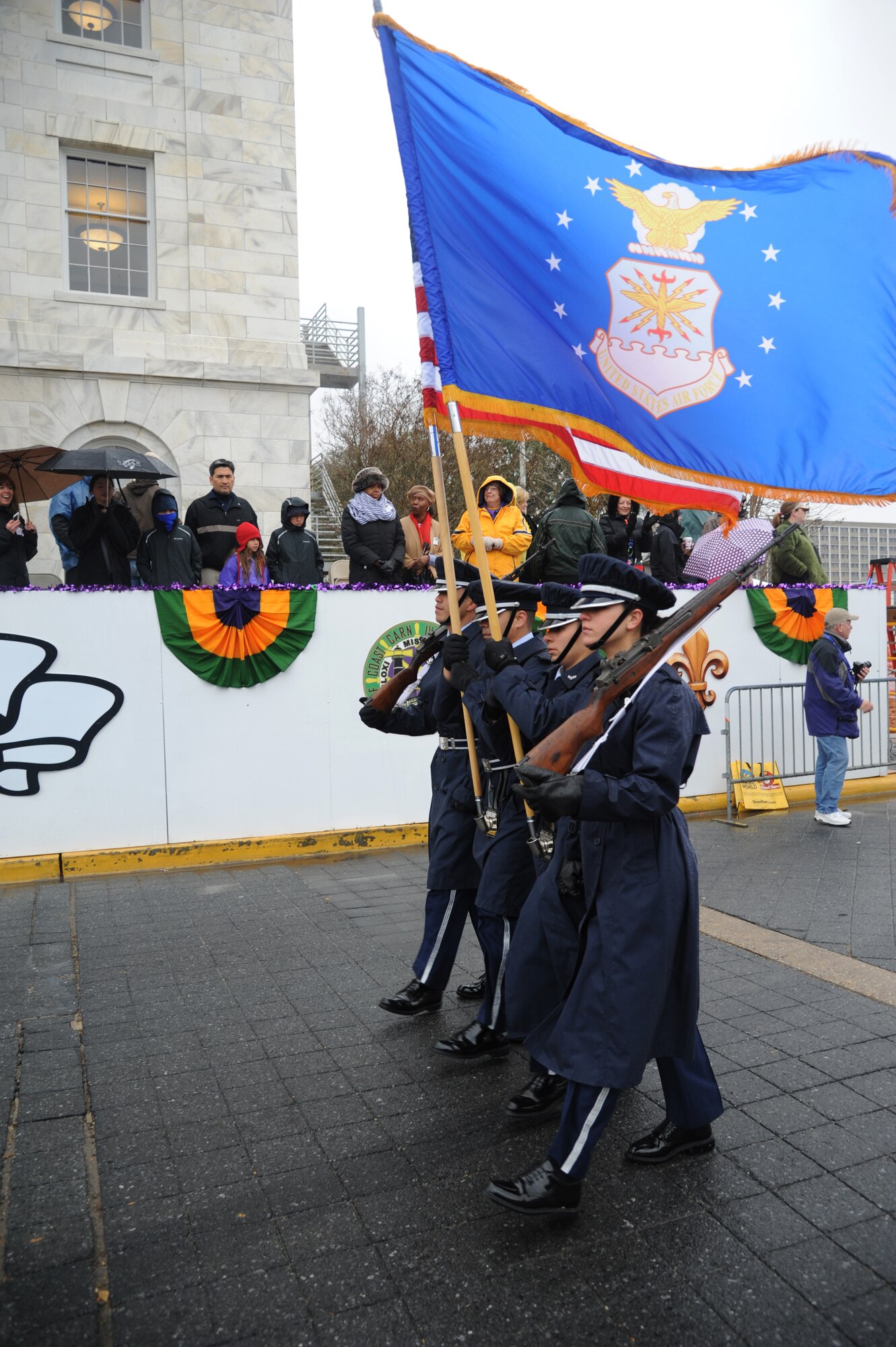 The Keesler Honor Guard leads the Gulf Coast Carnival Association Mardi Gras parade in Biloxi, Miss., March 4, 2014. Col. René Romero, 81st Training Wing vice commander, also participated in the festivities. (U.S. Air Force photo by Kemberly Groue)
