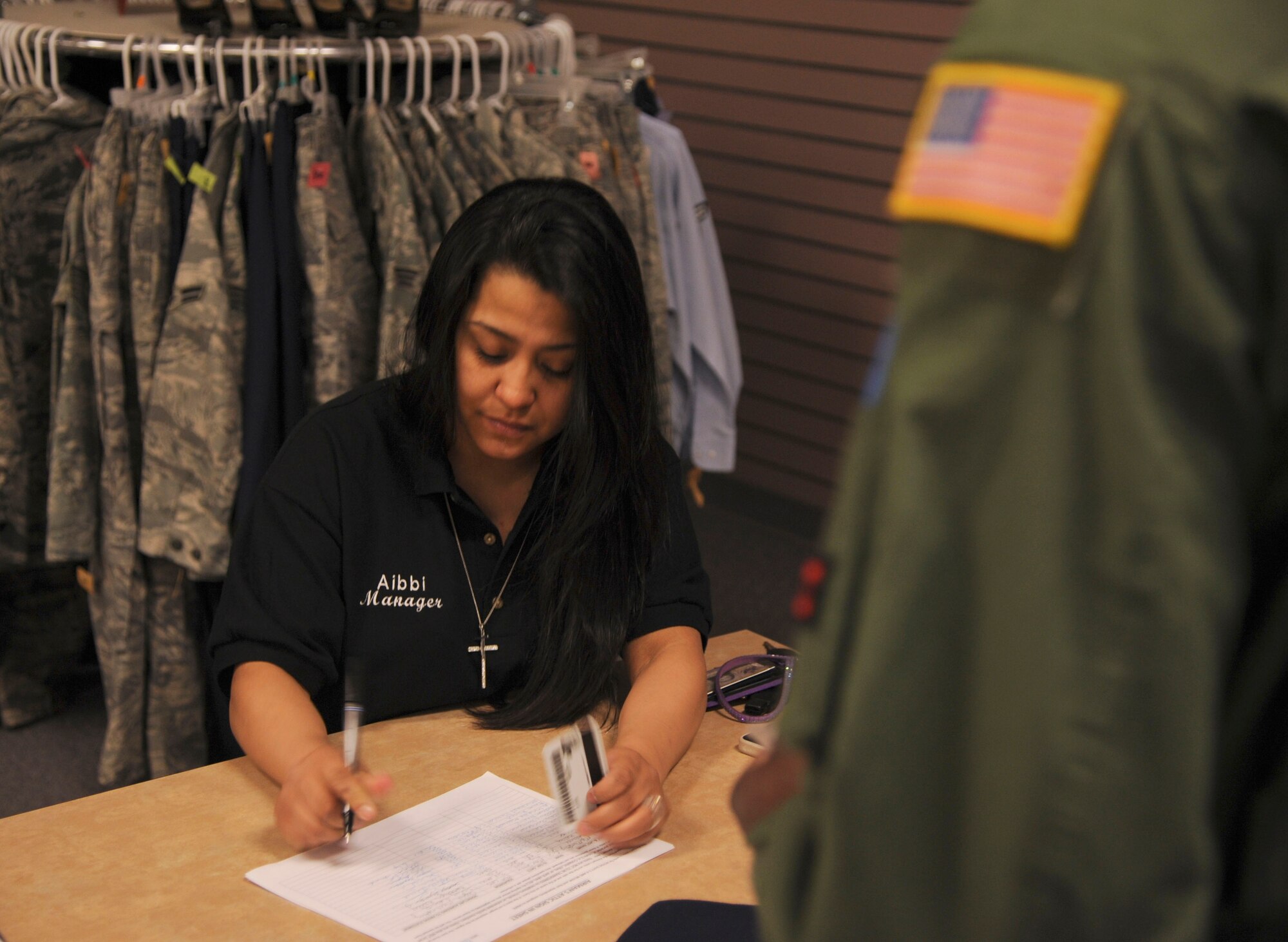 Aibii Esquivel, a Little Rock Air Force Base Airman’s Attic head volunteer, checks in an active-duty customer March 4, 2014 on Little Rock Air Force Base, Ark. On average, more than 150 people visit the Airman’s Attic every week. (U.S. Air Force photo by Airman 1st Class Harry Brexel)
