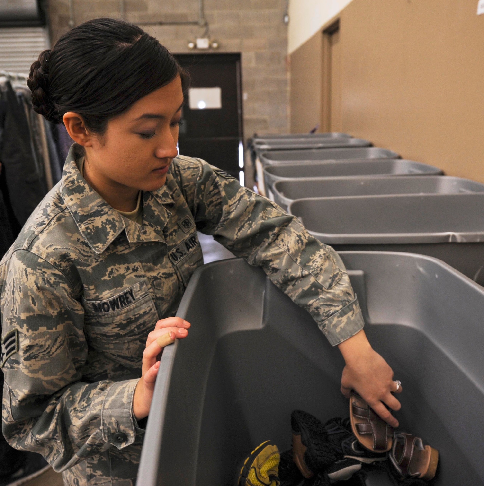 Senior Airman Meghan Mowrey, a 19th Medical Support Squadron journeyman, organizes shoes in the back of the Airman’s Attic March 4, 2014, at Little Rock Air Force Base, Ark. The Attic requires four to six volunteers each week in order to operate. (U.S. Air Force photo by Airman 1st Class Harry Brexel)