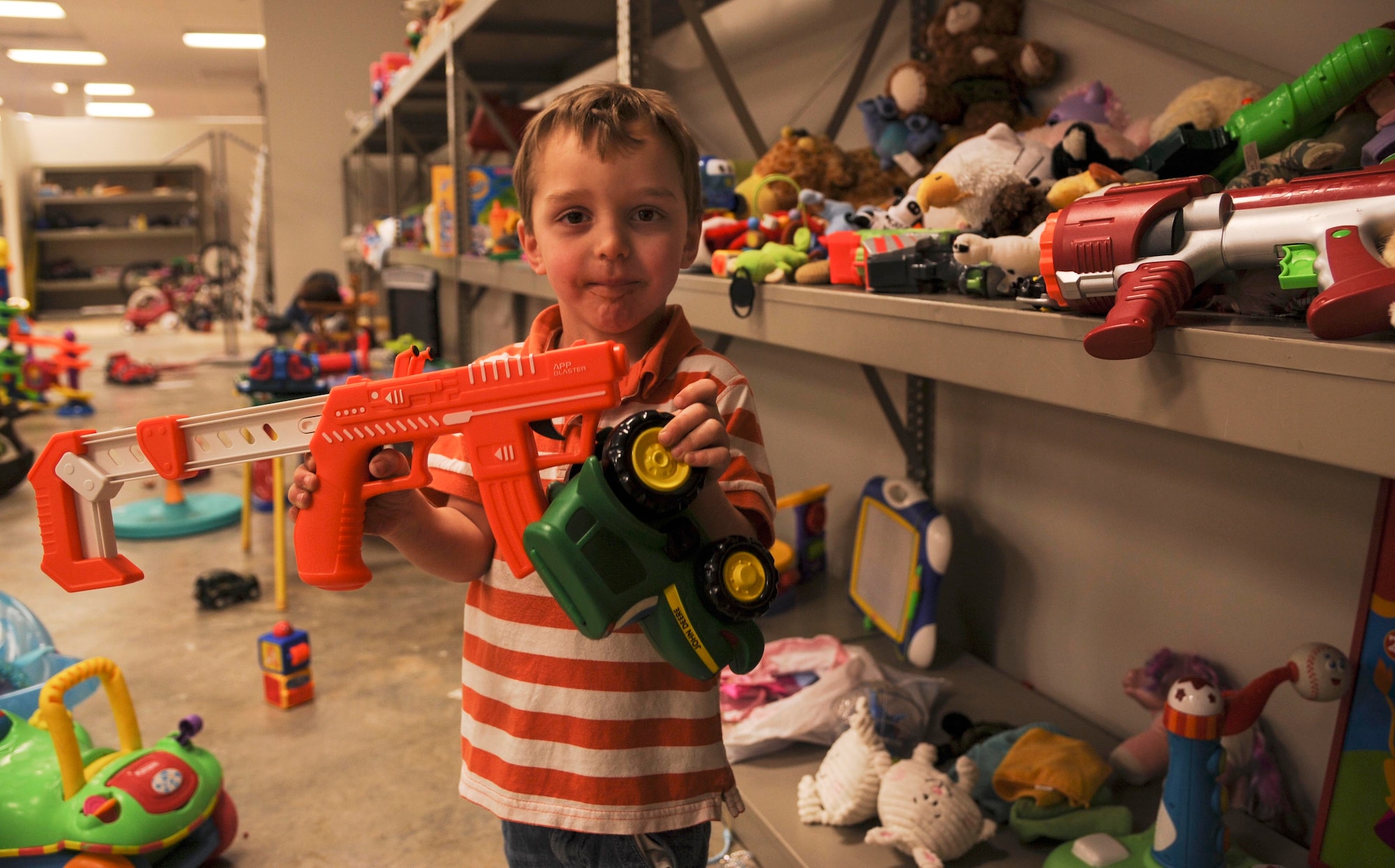 Landon plays with new toys he found at the Airman’s Attic March 4, 2014, at Little Rock Air Force Base, Ark. Toys are just one of the many items that the Airman’s Attic offers, free of charge to Airmen E-6 and below. (U.S. Air Force photo by Airman 1st Class Harry Brexel)