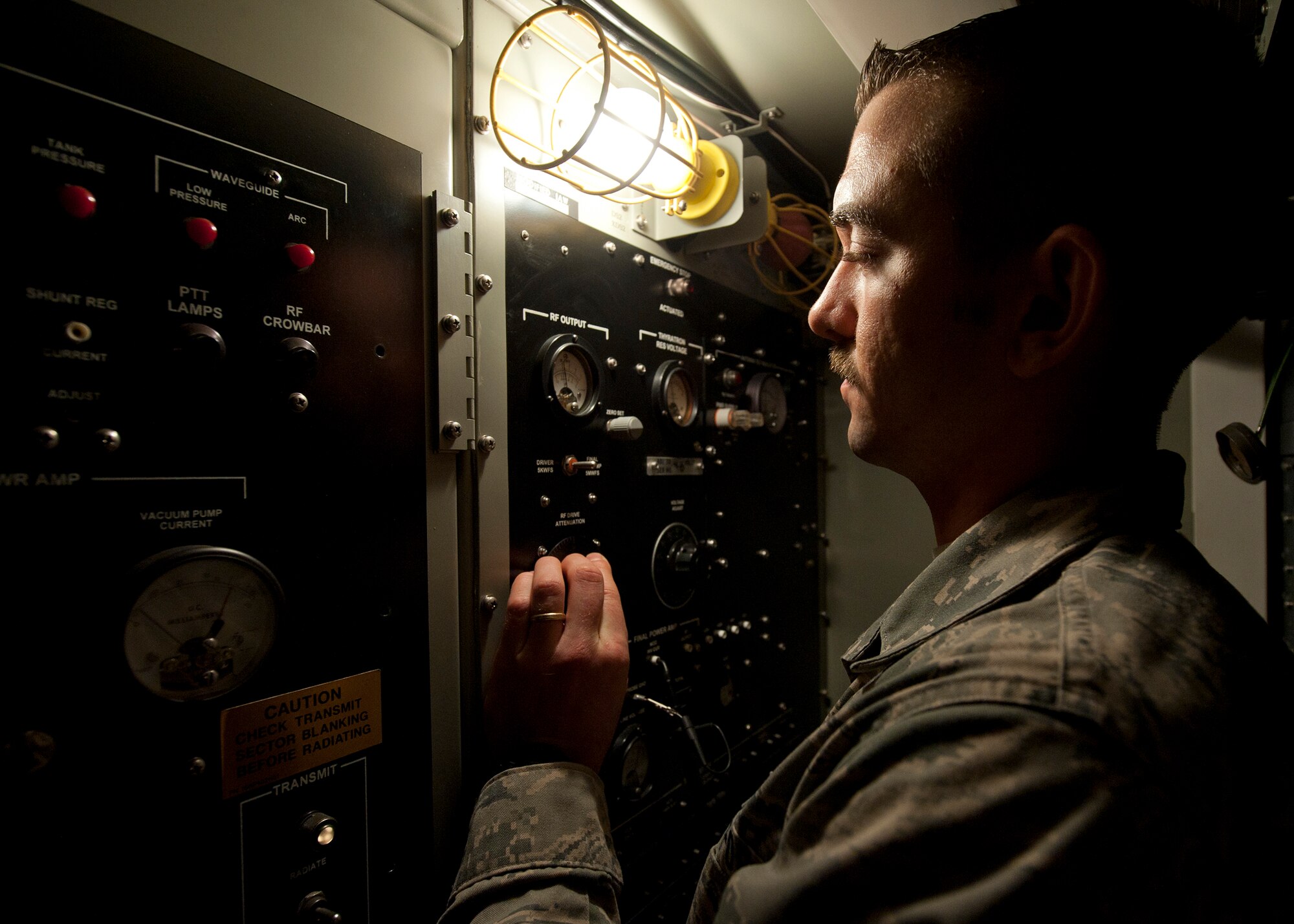 Staff Sgt. Aaron Driver, a ground radar systems technician assigned to the 727th Expeditionary Air Control Squadron, adjusts the power to the radar at an undisclosed location in Southwest Asia, March 5, 2014. Driver is a native of Savannah, Ga., and is deployed here from Hunter Army Airfield. (U.S. Air Force photo by Staff Sgt. Michael Means/Released)