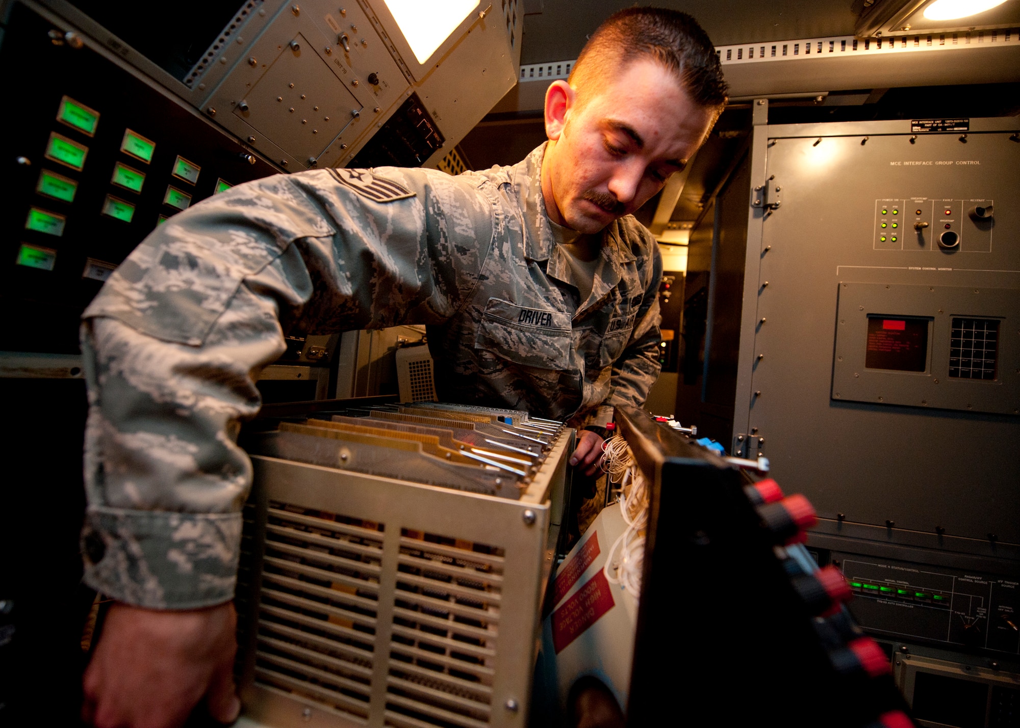 Staff Sgt. Aaron Driver, a ground radar systems technician assigned to the 727th Expeditionary Air Control Squadron, performs preventative maintenance on a YUK-27 at an undisclosed location in Southwest Asia, March 5, 2014. Driver is a native of Savannah, Ga., and is deployed here from Hunter Army Airfield. (U.S. Air Force photo by Staff Sgt. Michael Means/Released)