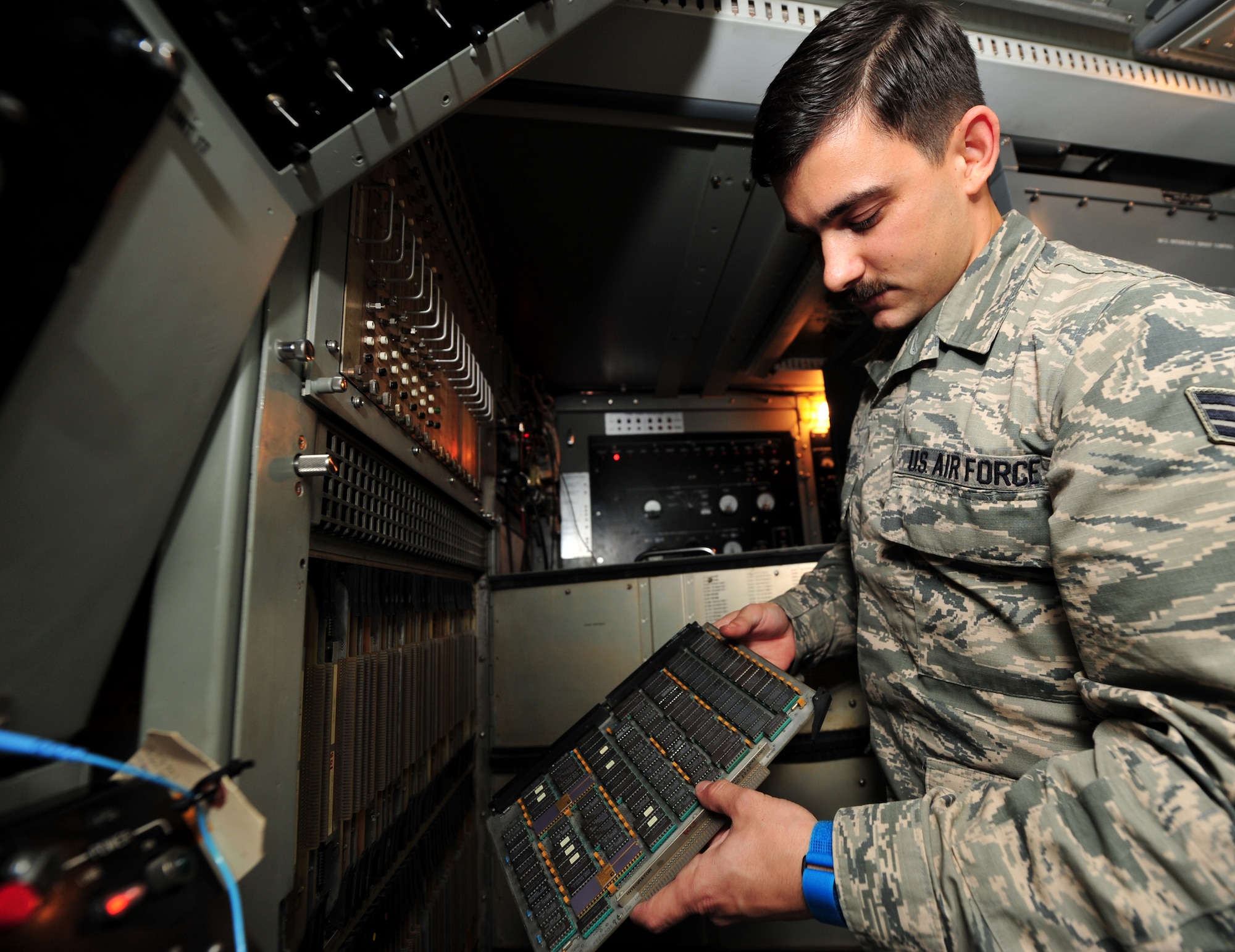 Senior Airman Blake Elkin, a ground radar systems technician assigned to the 727th Expeditionary Air Control Squadron, inspects a single processor circuit card at an undisclosed location in Southwest Asia, March 3, 2014. Elkin is a native of Phoenix, Ariz., and is deployed here from Hunter Army Airfield in Savannah, Ga. (U.S. Air Force photo by Staff Sgt. Michael Means/Released)